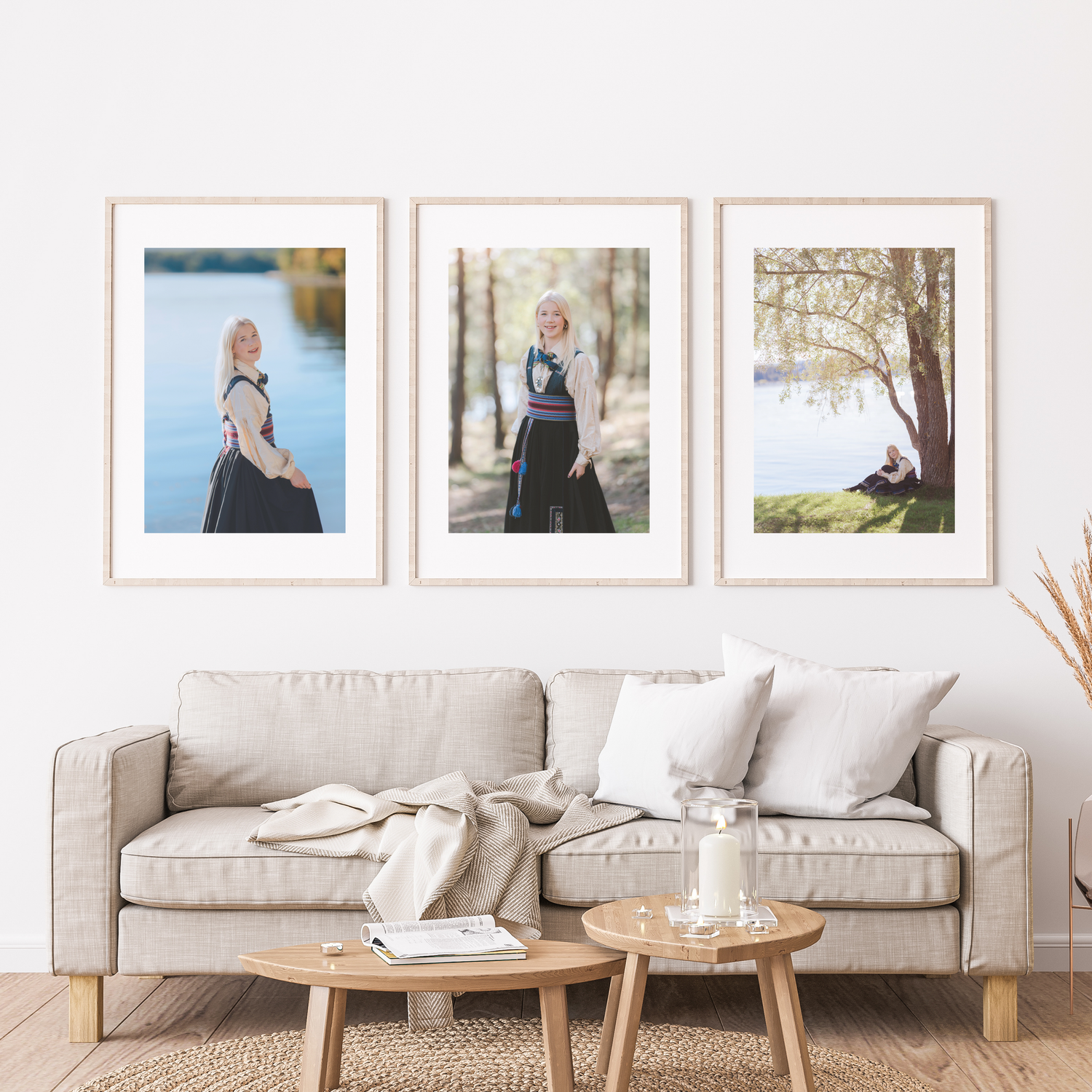 Modern living room interior with beige sofa, wooden coffee tables and framed artwork on white walls.