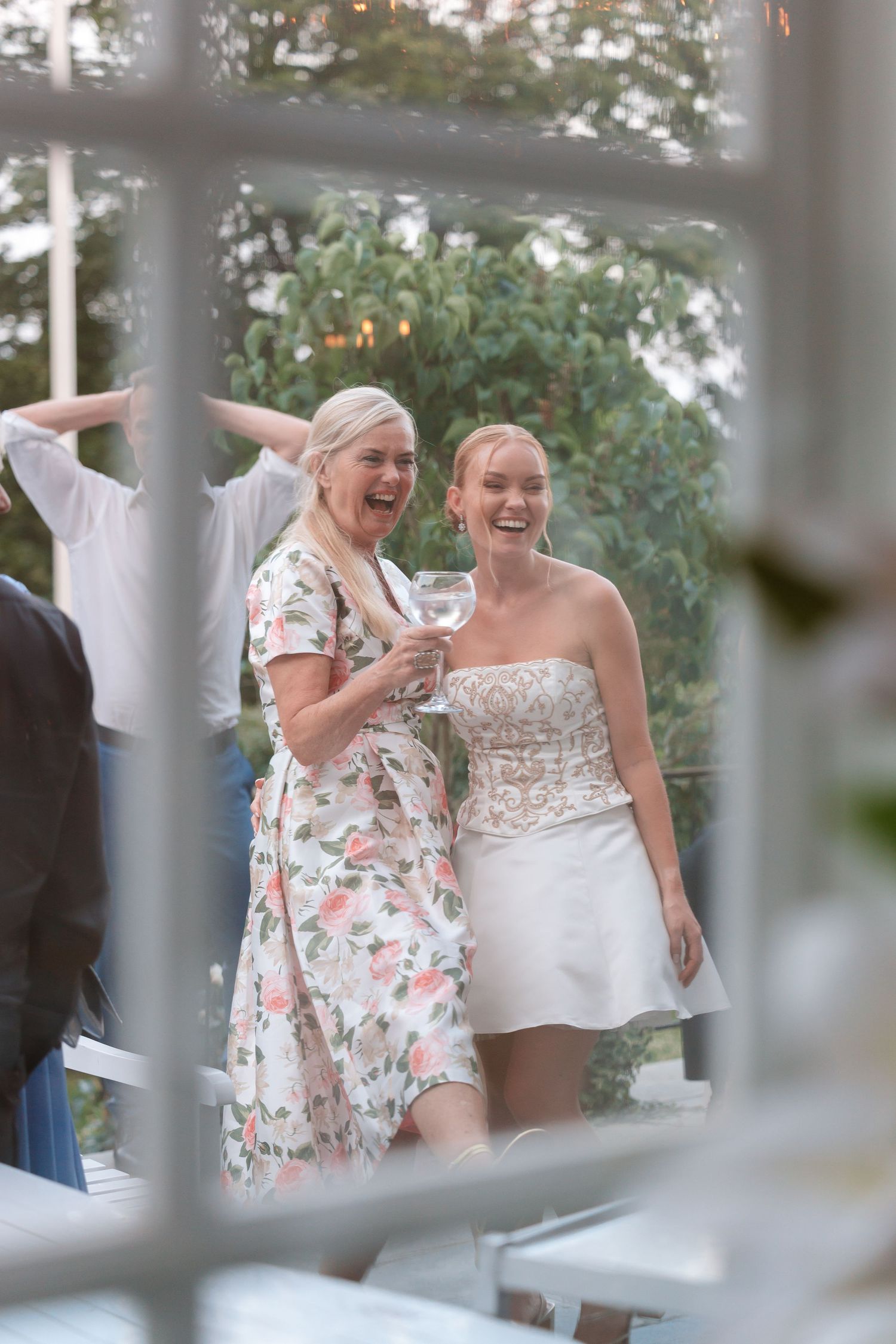 Three candid moments show people sharing joyful laughter at an outdoor wedding celebration.