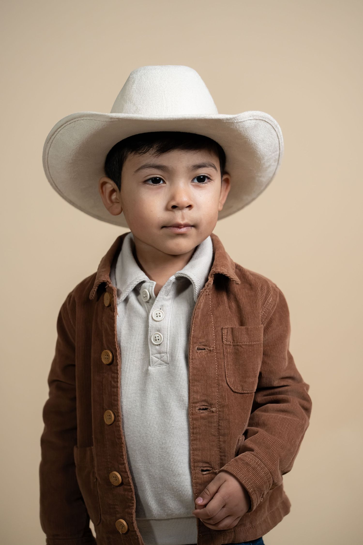 Child wearing cowboy hat during studio portrait session in Nampa Idaho