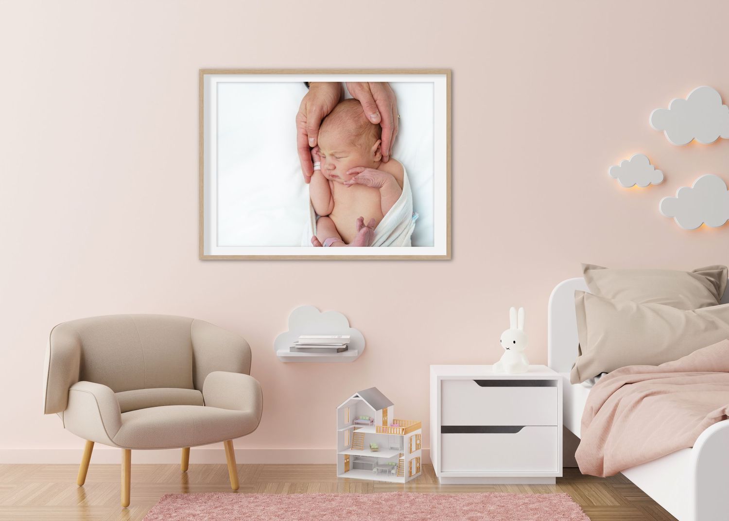 Soft pink nursery room with modern furniture and delicate wall decor creating a peaceful atmosphere.