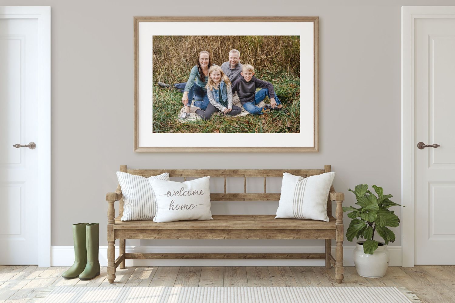 Stylish entryway with paneled walls, bench seating, and family photographs displayed in wooden frames.
