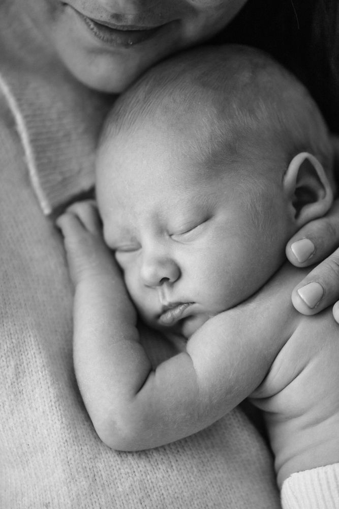 Peaceful black and white series of close-up photos showing a sleeping newborn baby in soft light.