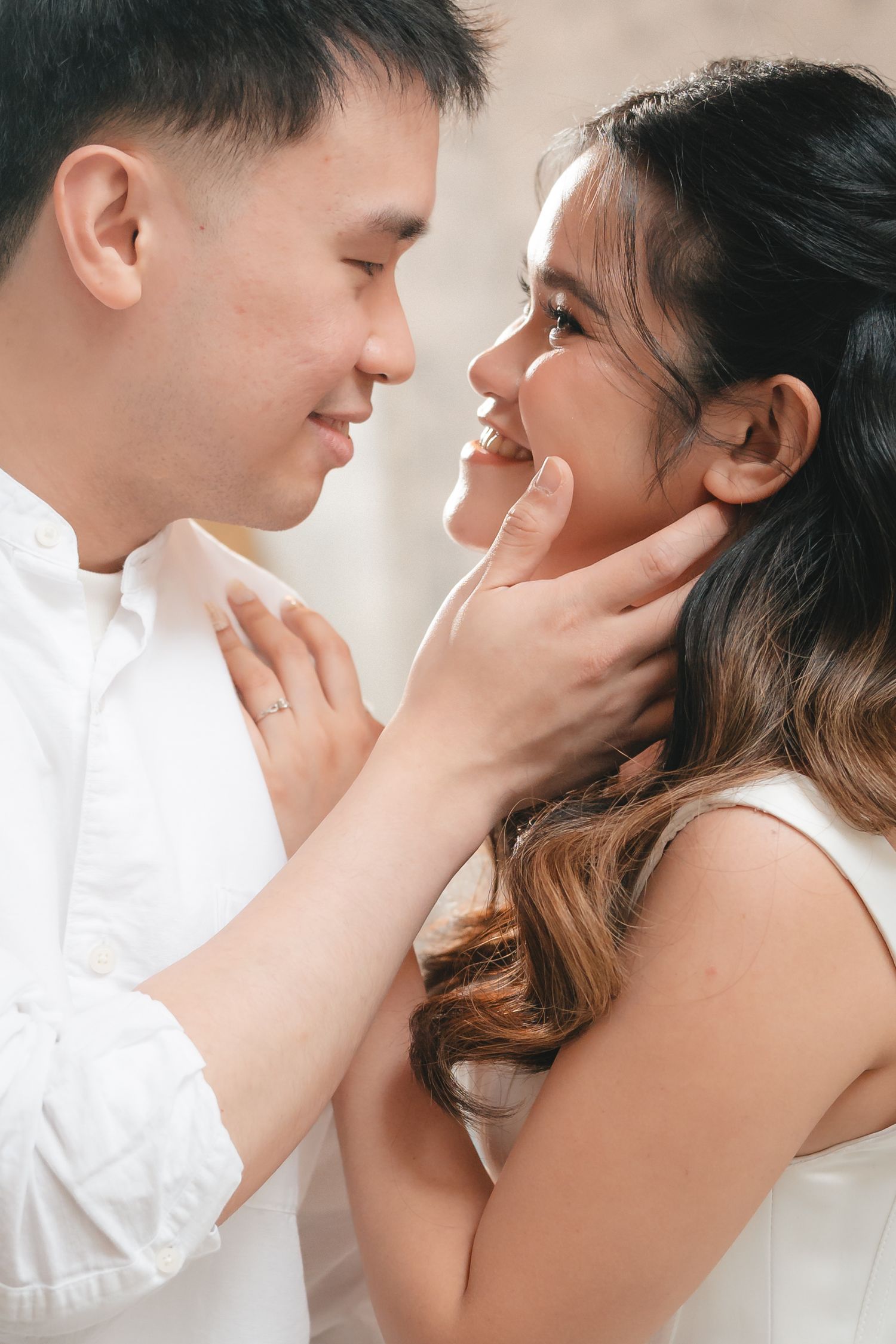 Romantic couple in white clothing sharing intimate moments in a series of tender close-up photos.