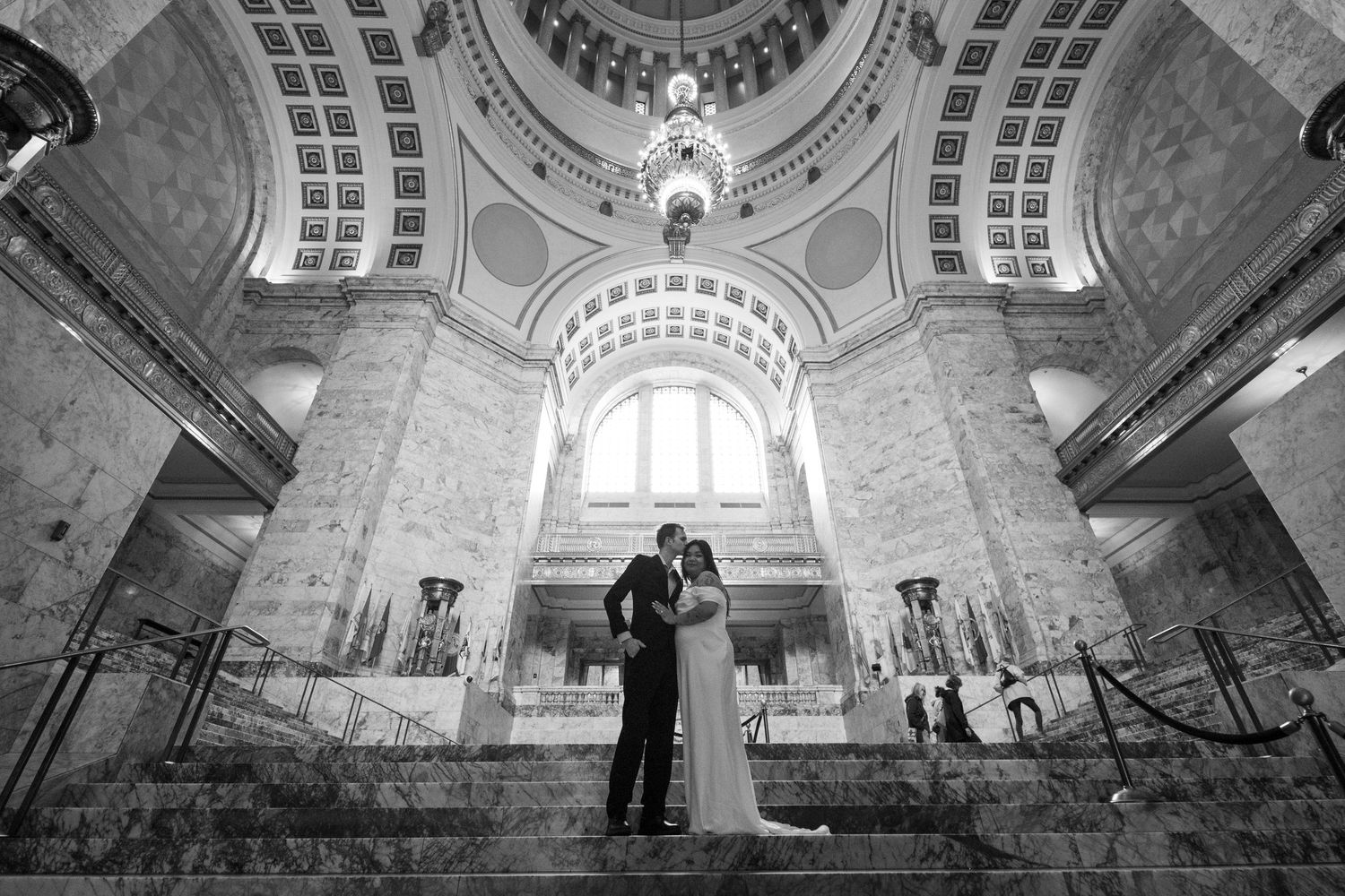 A black and white photo sequence showing a couple dancing in an ornate historic building with domed architecture.