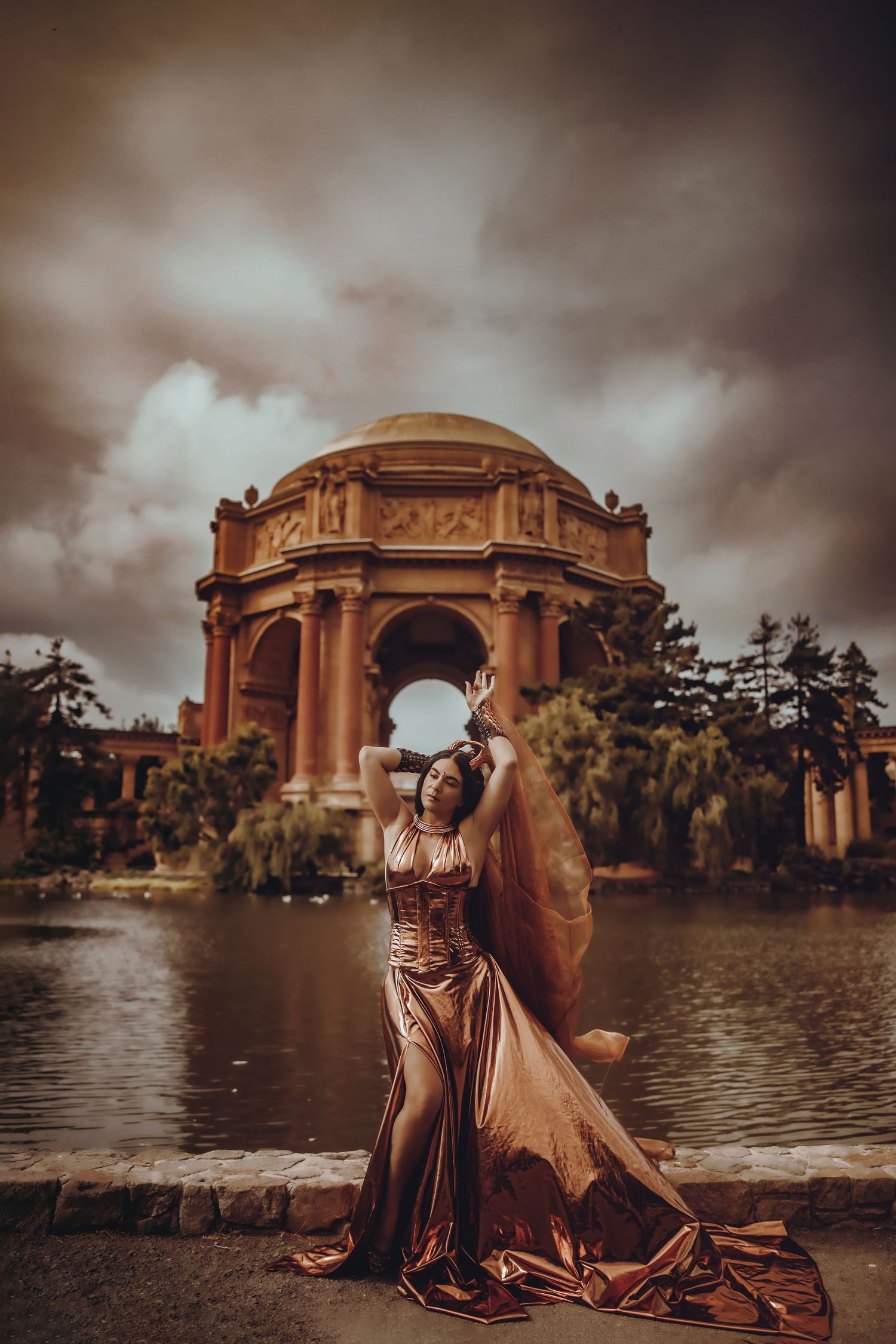 Dramatic photo series at the Palace of Fine Arts in San Francisco with moody clouds and golden architecture at sunset.