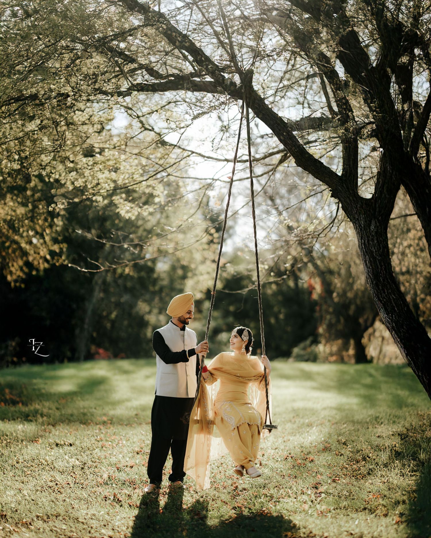 Punjabi boy playfully giving swings to his girl during joyful outdoor photoshoot in toronto