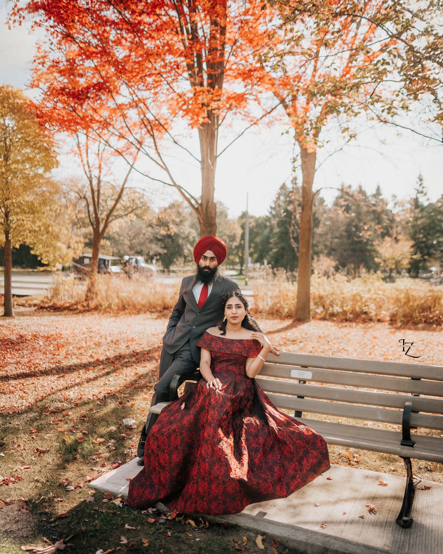 ntimate moment of Punjabi couple seated together, sharing a gaze in colorful traditional attire in toronto