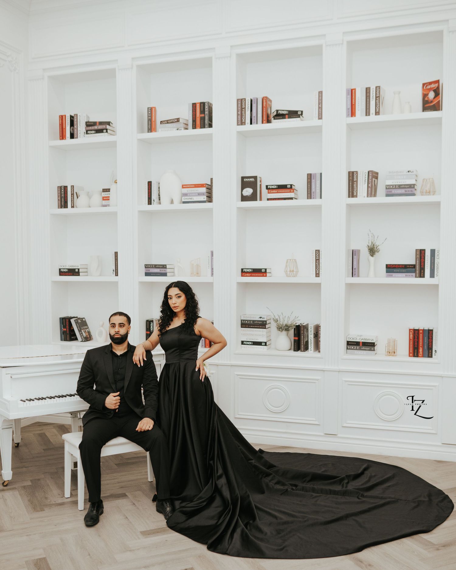 Modern Indian engagement shoot with couple standing indoors, bride in chic Western dress, shoot done in studio in toronto