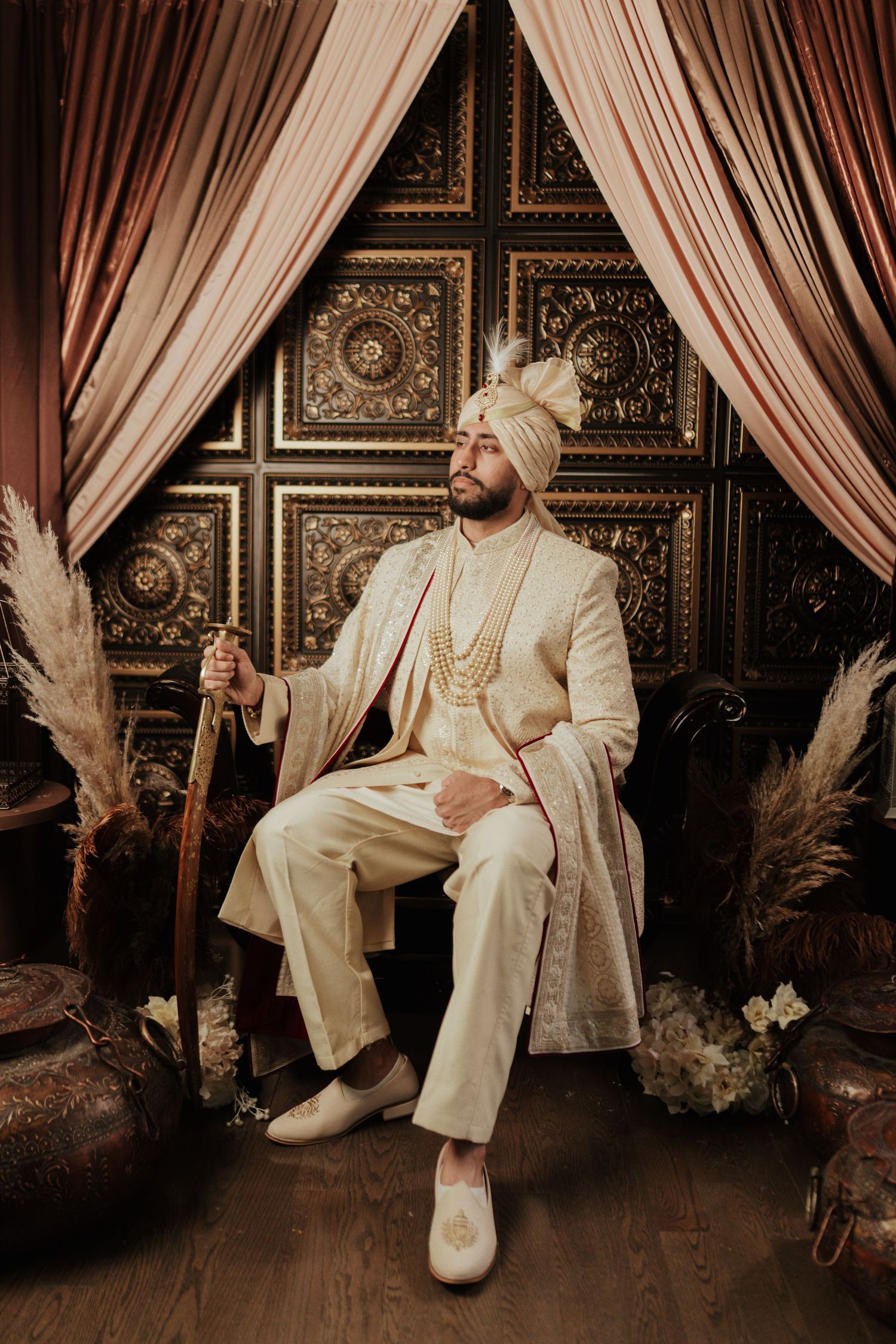 Groom preparing for wedding ceremony during getting ready photoshoot, dressed in traditional attire in toronto