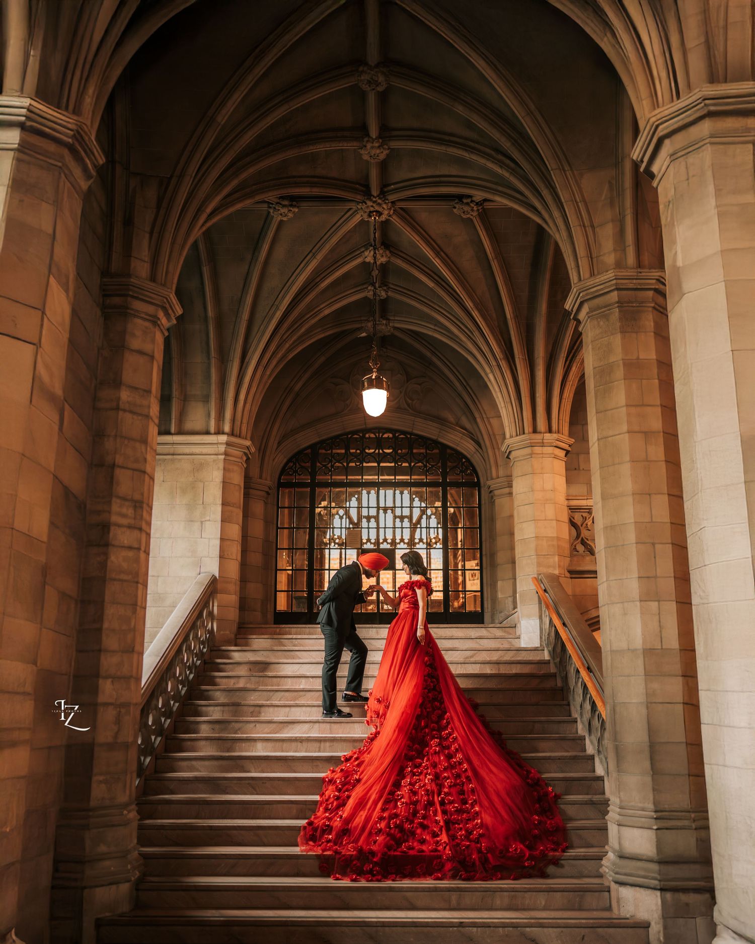 Graceful Punjabi couple at Knox College, with the bride in a flowing red gown framed by stunning historic architecture