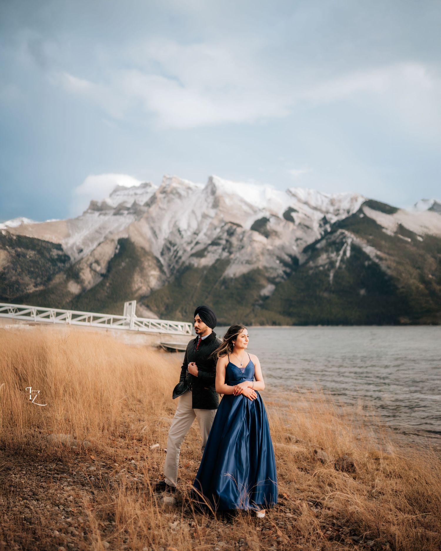 Stunning Indian couple posing beautifully with majestic Rocky Mountains backdrop during outdoor engagement photoshoot in Banff National Park