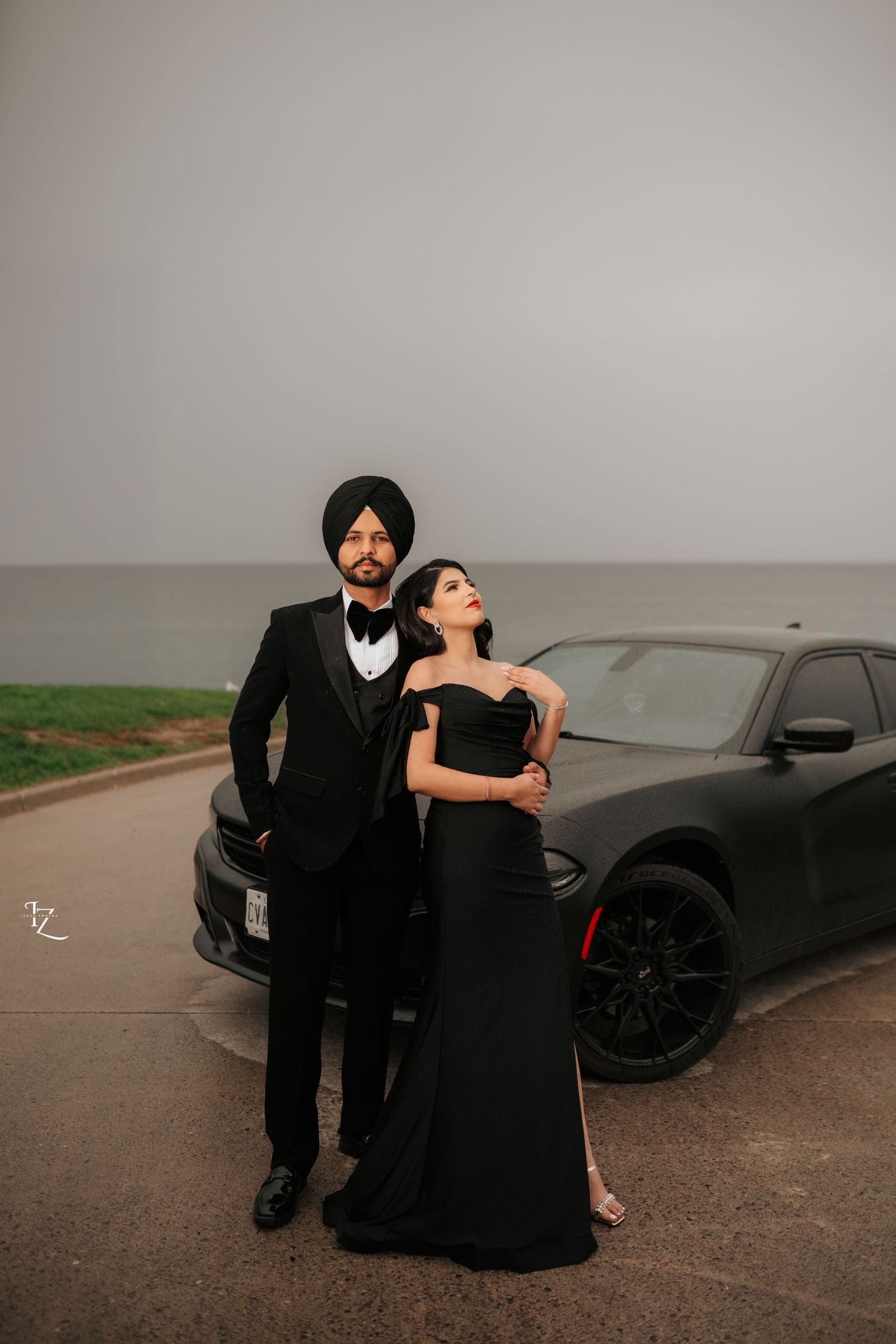 Chic and stylish couple dressed in sleek black outfits, striking a confident, model-inspired pose during their engagement photoshoot
