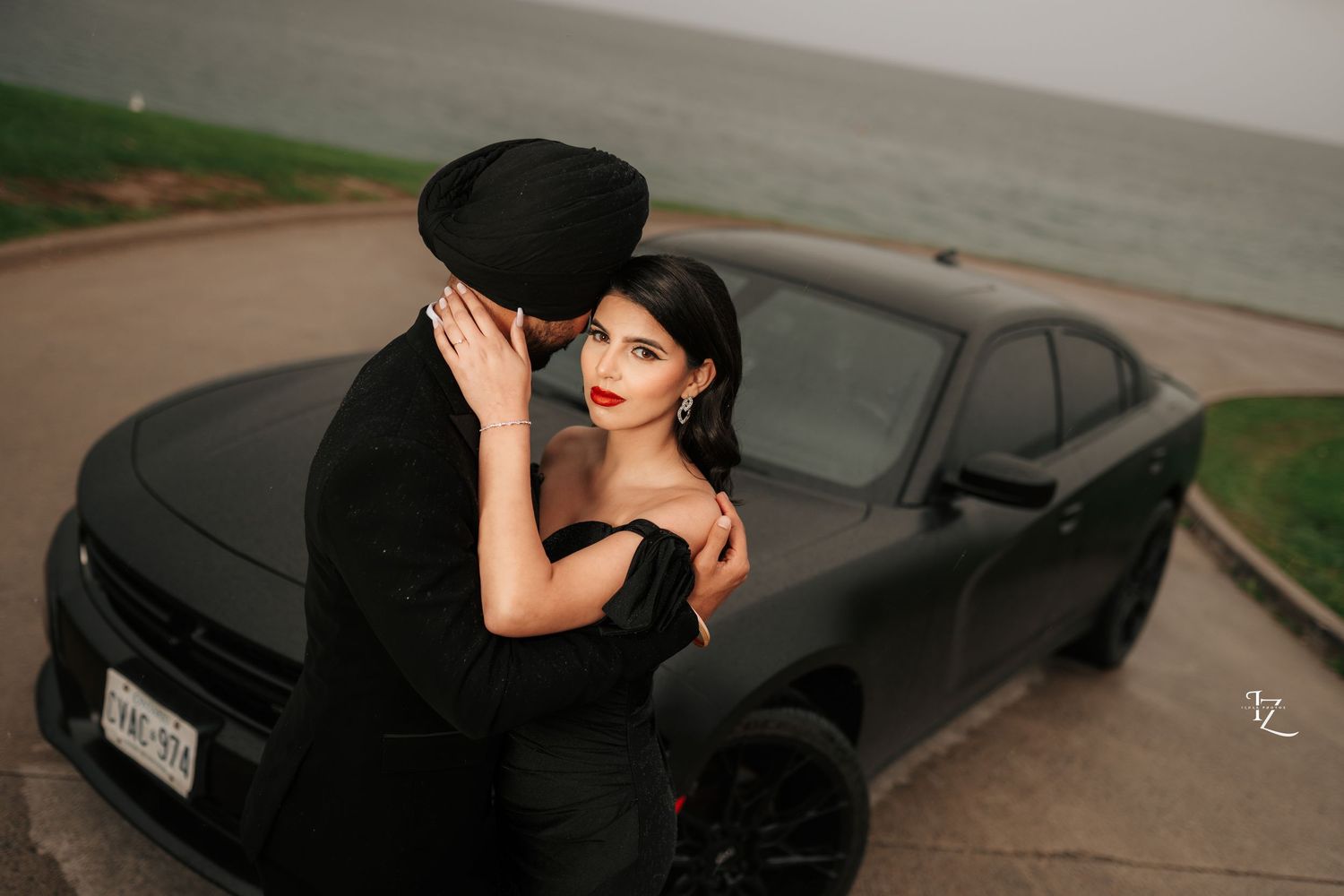 Stylish couple in black outfits striking a model-inspired pose during engagement photoshoot