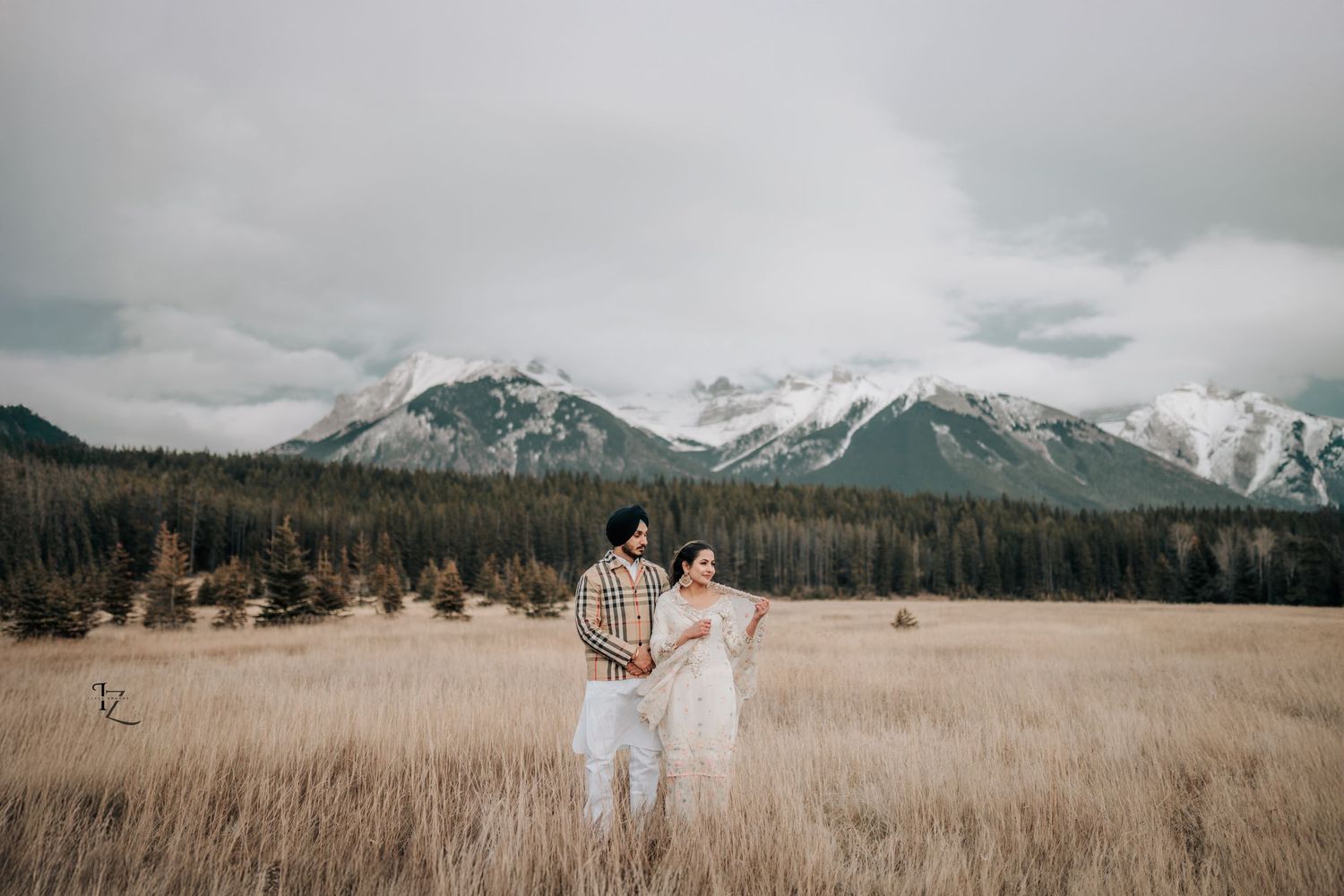 Indian bride and groom in cultural and contemporary attire during Banff outdoor photoshoot capturing love and nature