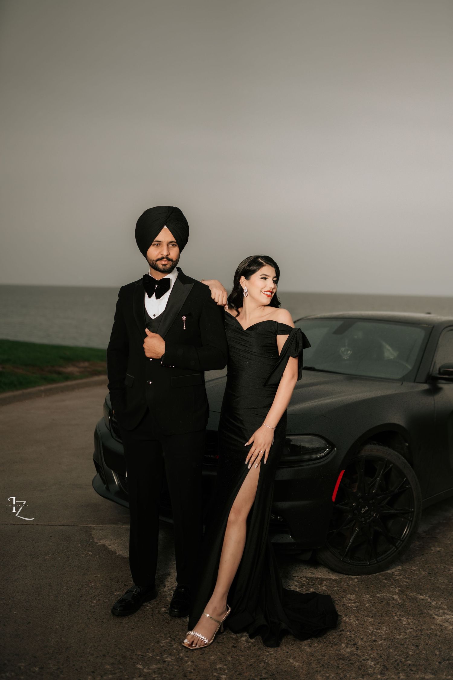 Stylish couple in black outfits striking a model-inspired pose during engagement photoshoot