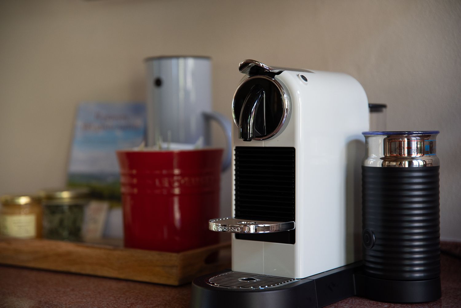 Coffee station with modern espresso machines and brewing equipment on a kitchen counter.