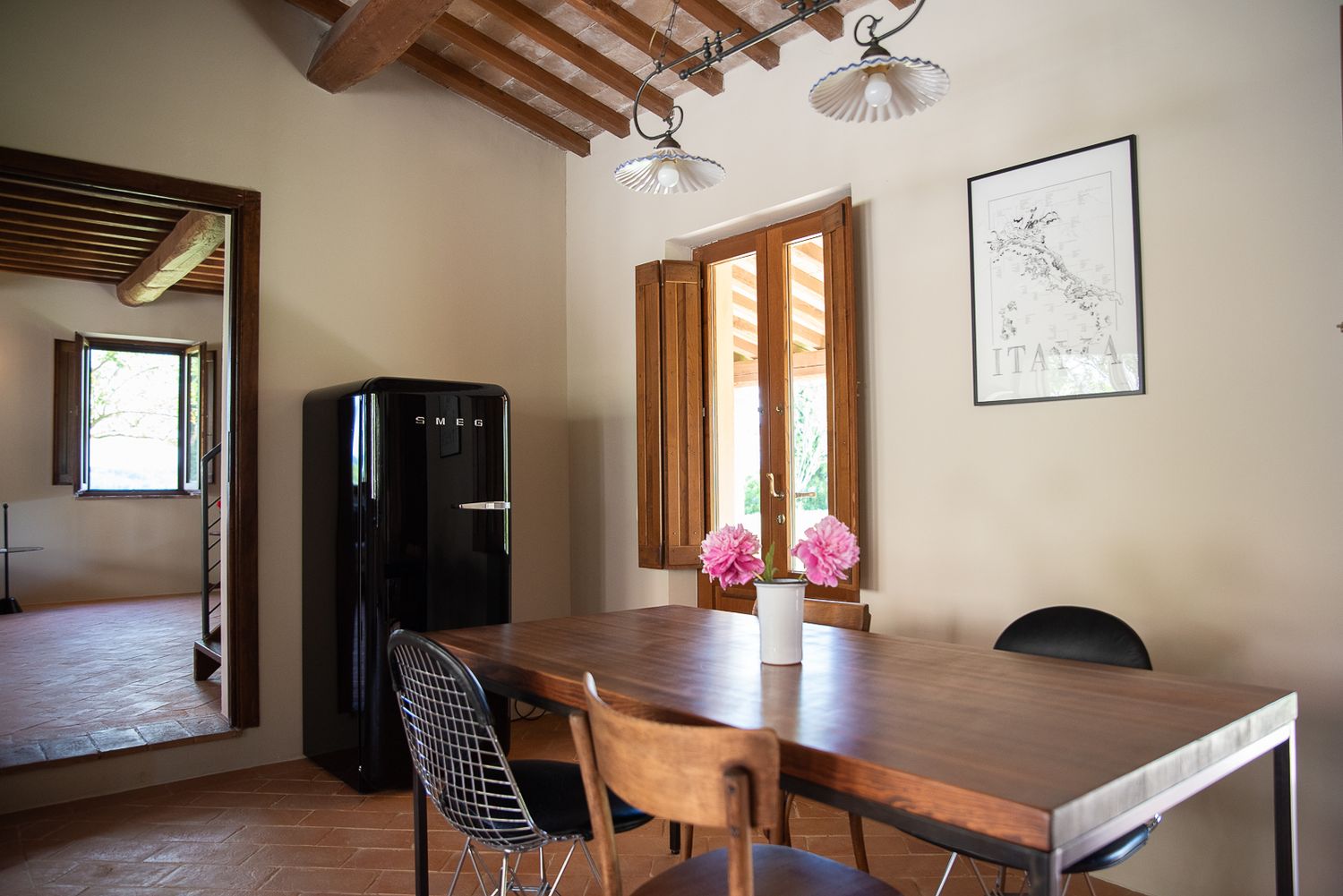 Open concept living space with wooden ceiling beams, modern furniture and natural light.