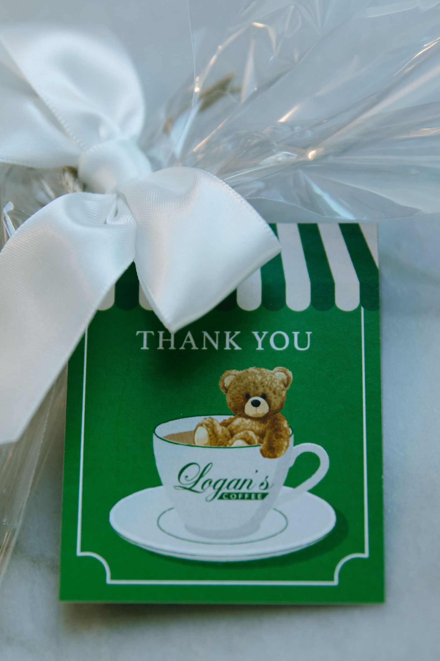 Green thank you cards with teddy bear and coffee cup designs wrapped in clear packaging.
