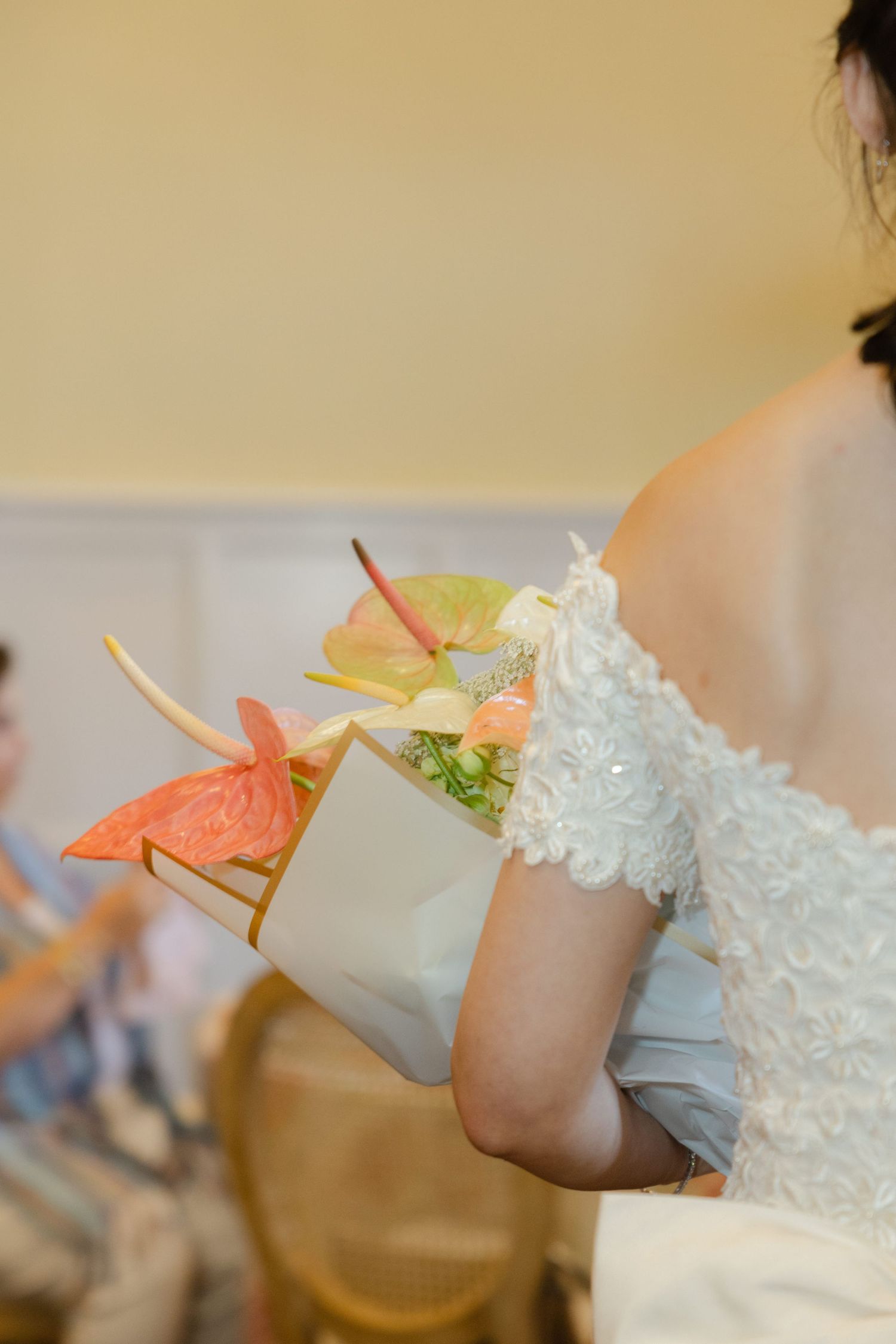 Close-up of delicate lace sleeve details with soft peach and white accents.