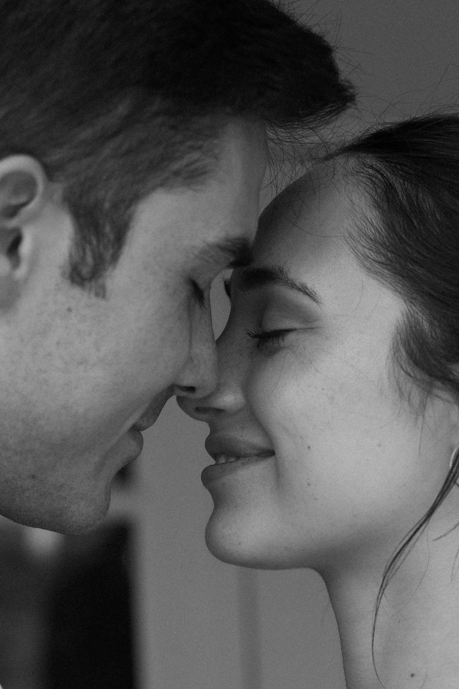 Intimate black and white close-up portrait showing tender romantic moment.