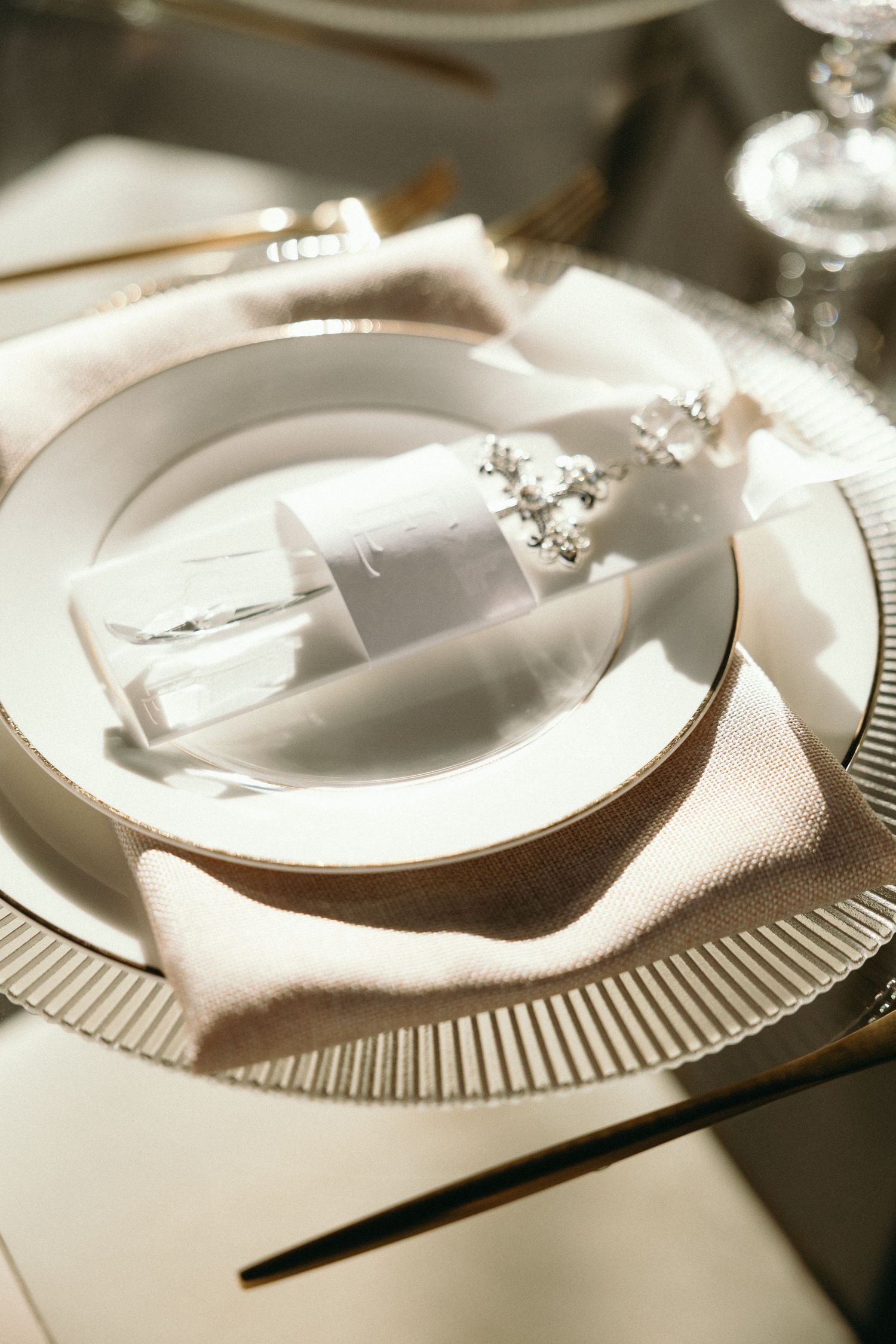 Elegant place settings with white plates and napkins arranged on a formal dining table.