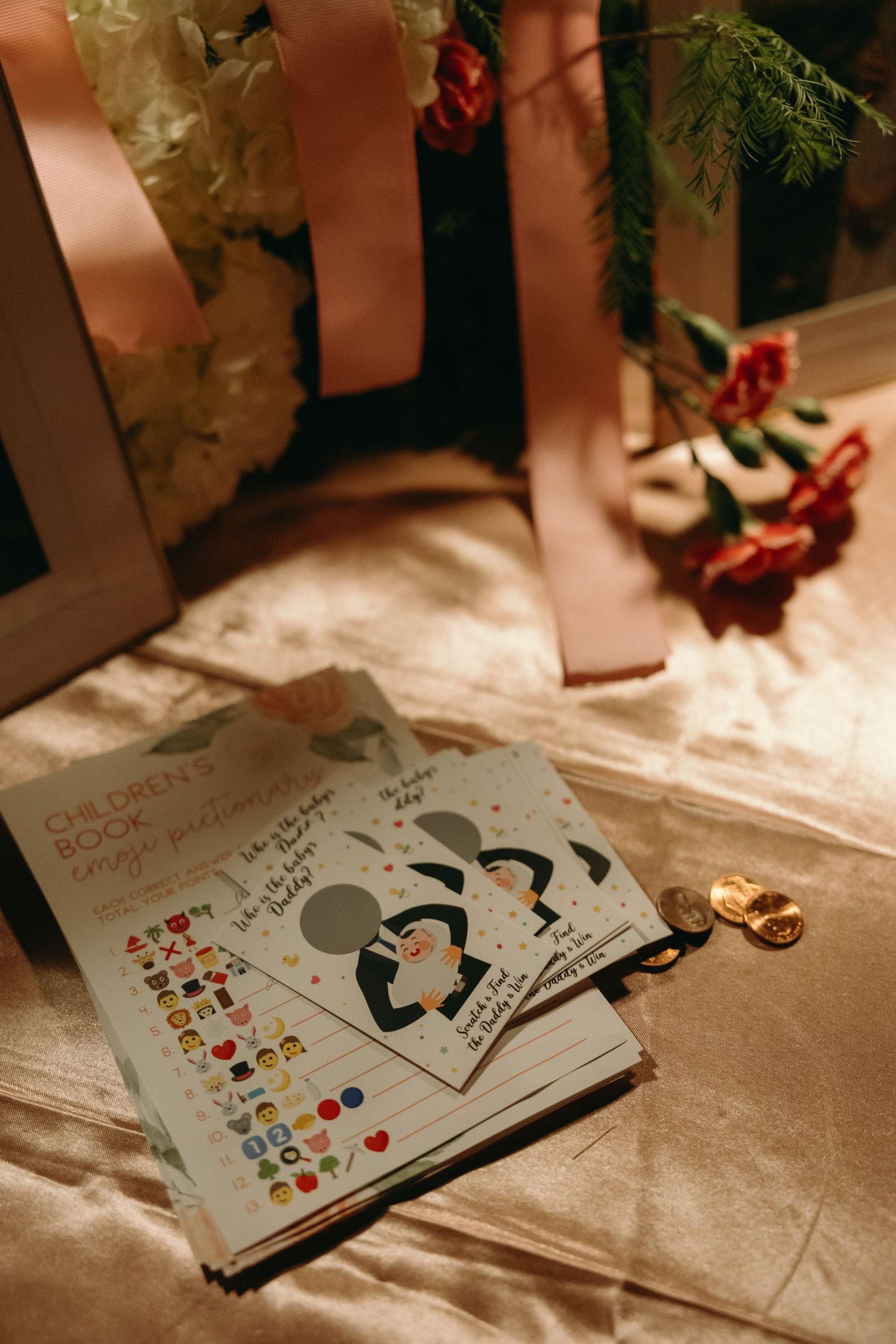 Handwritten cards and notes scattered on a textured surface with floral decorations.