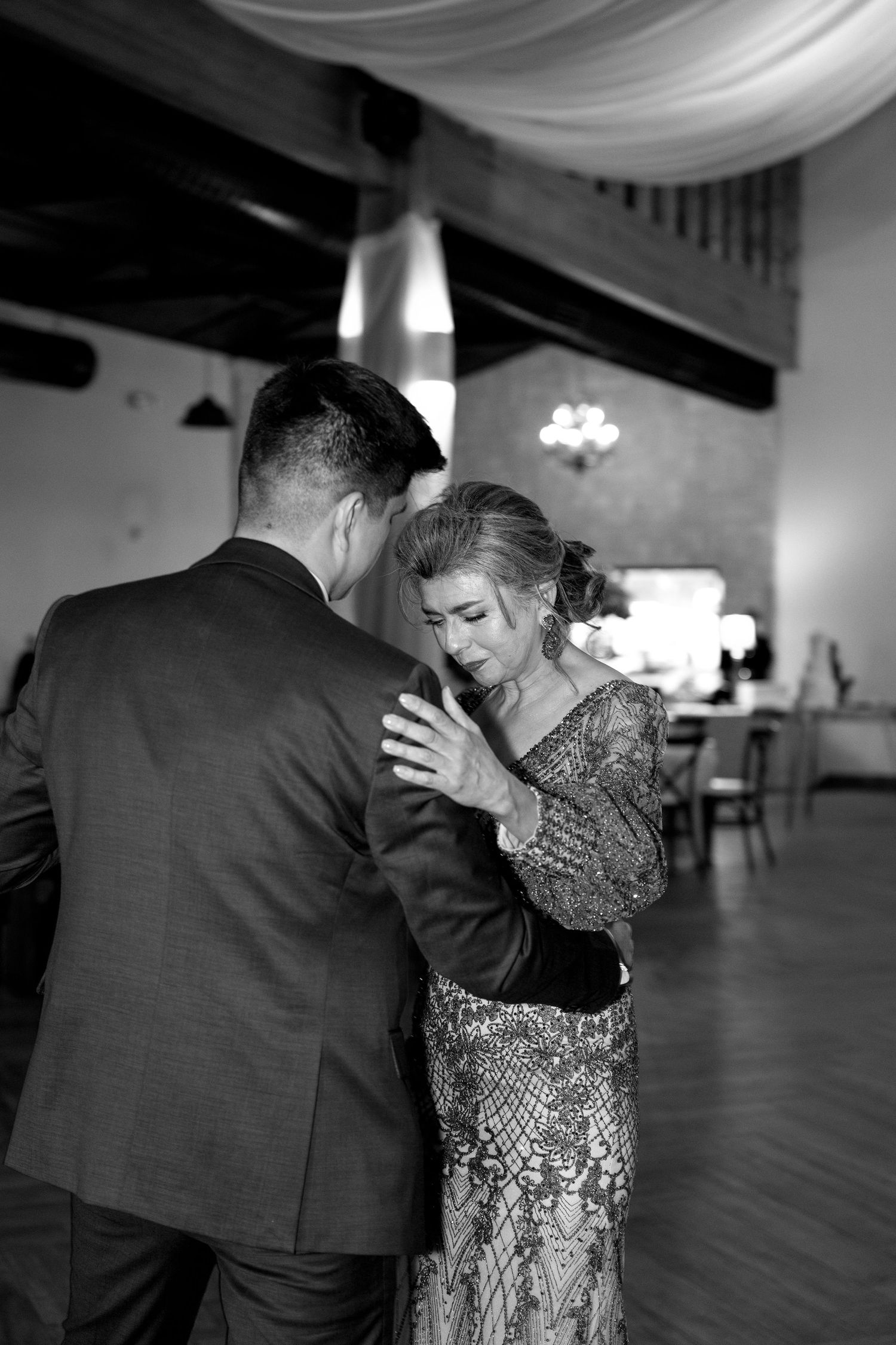 Dancing couple sharing an intimate moment on the ballroom floor.