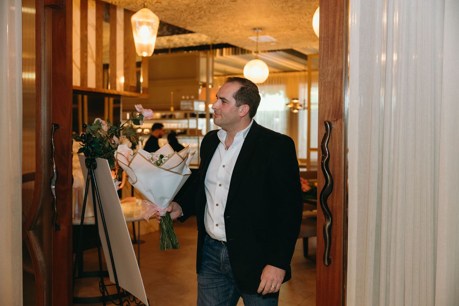 Elegant hallway decorated with hanging pendant lights and warm ambient lighting for a special event.