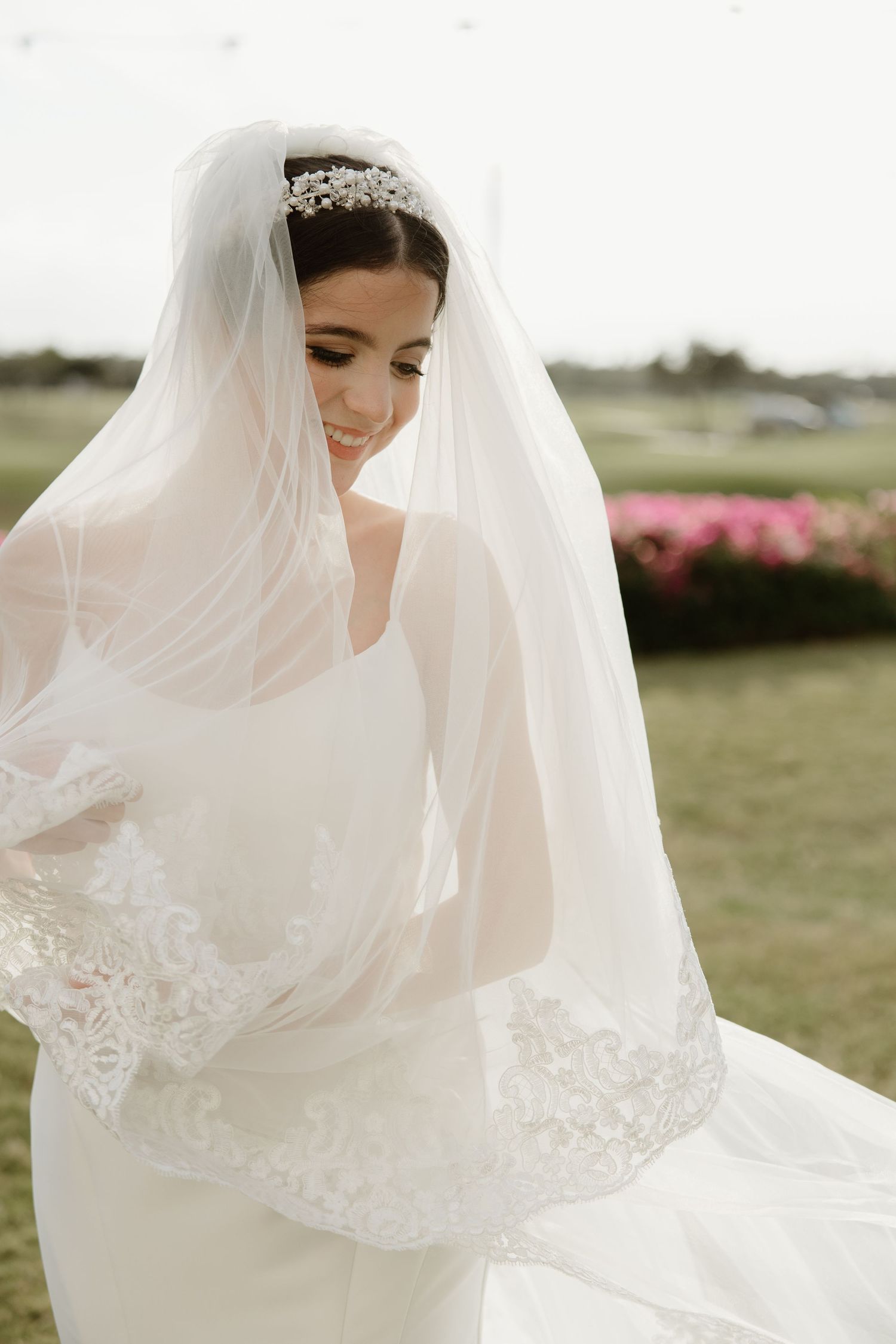 Ethereal bridal portraits showing delicate lace veil details in natural outdoor lighting.