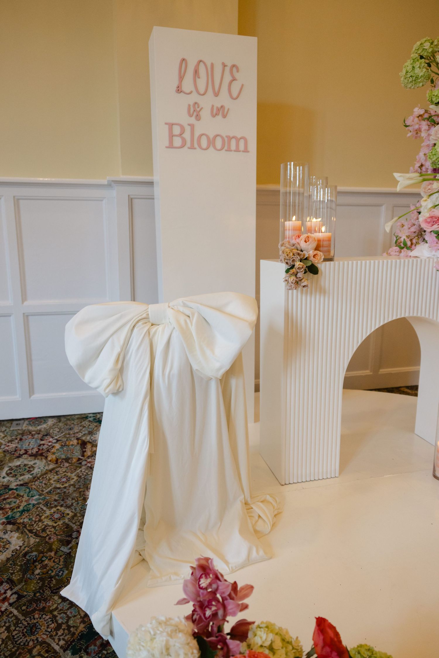 White decorative umbrellas and romantic signage create an elegant wedding display setup.
