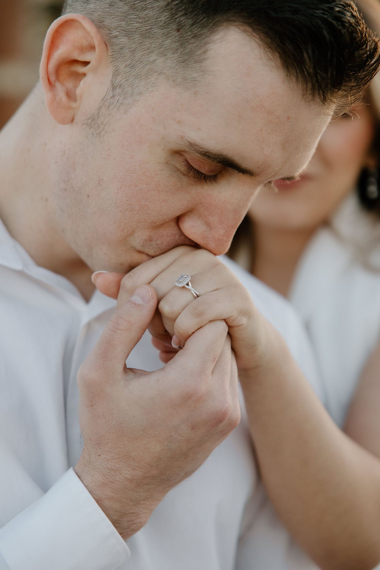 Intimate close-up of a couple sharing a tender moment in soft lighting.