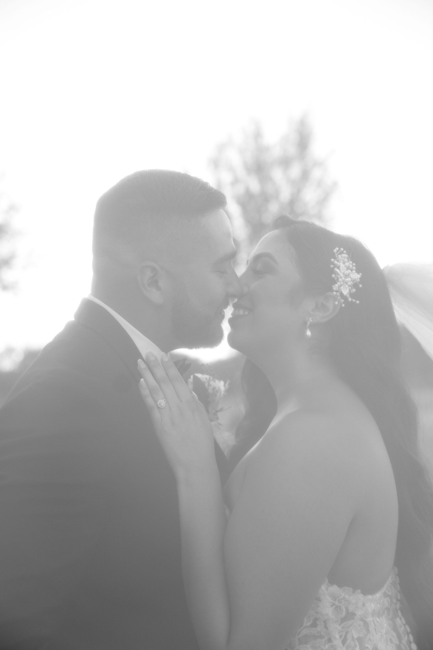 Romantic sunset silhouette of newlyweds sharing intimate moments during their outdoor wedding photoshoot.