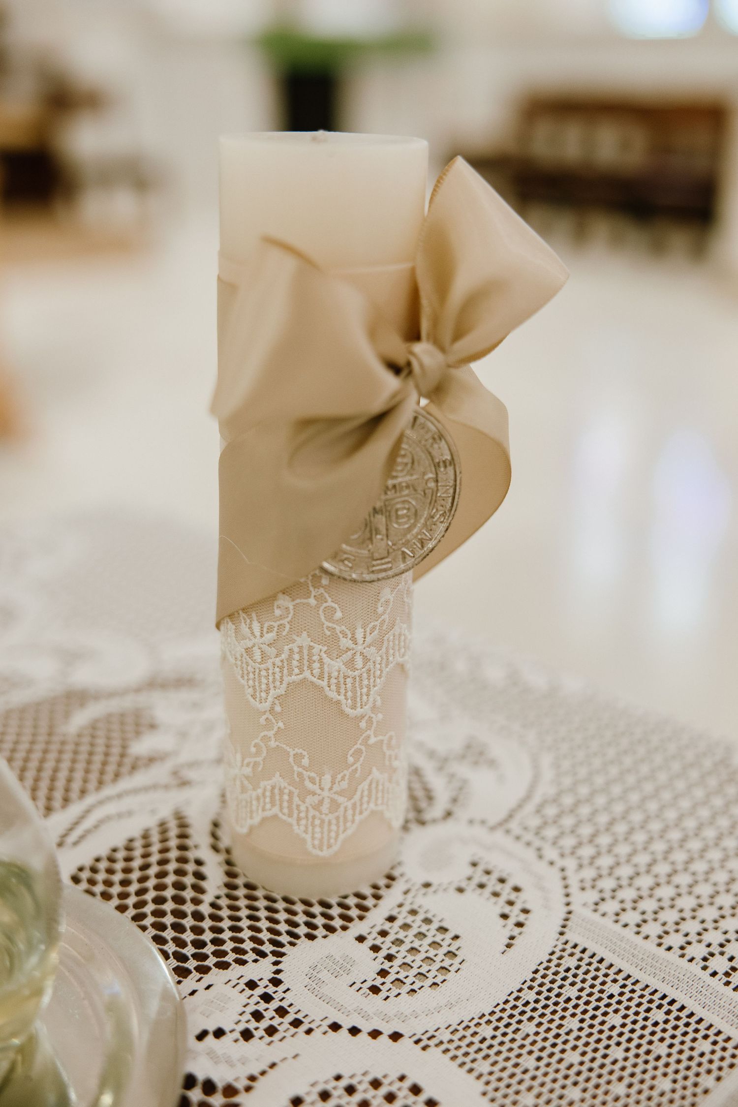 Intricate lace pattern detail on cream-colored fabric with delicate embroidery.