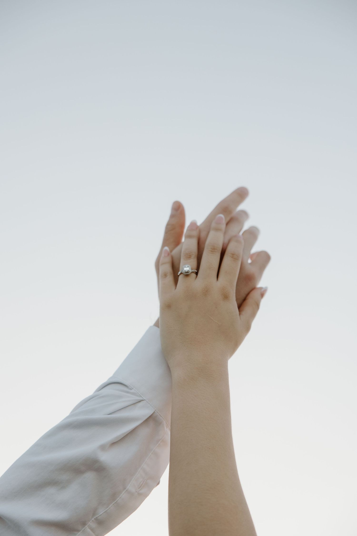 Close-up sequence showing hands clasped together with engagement ring.