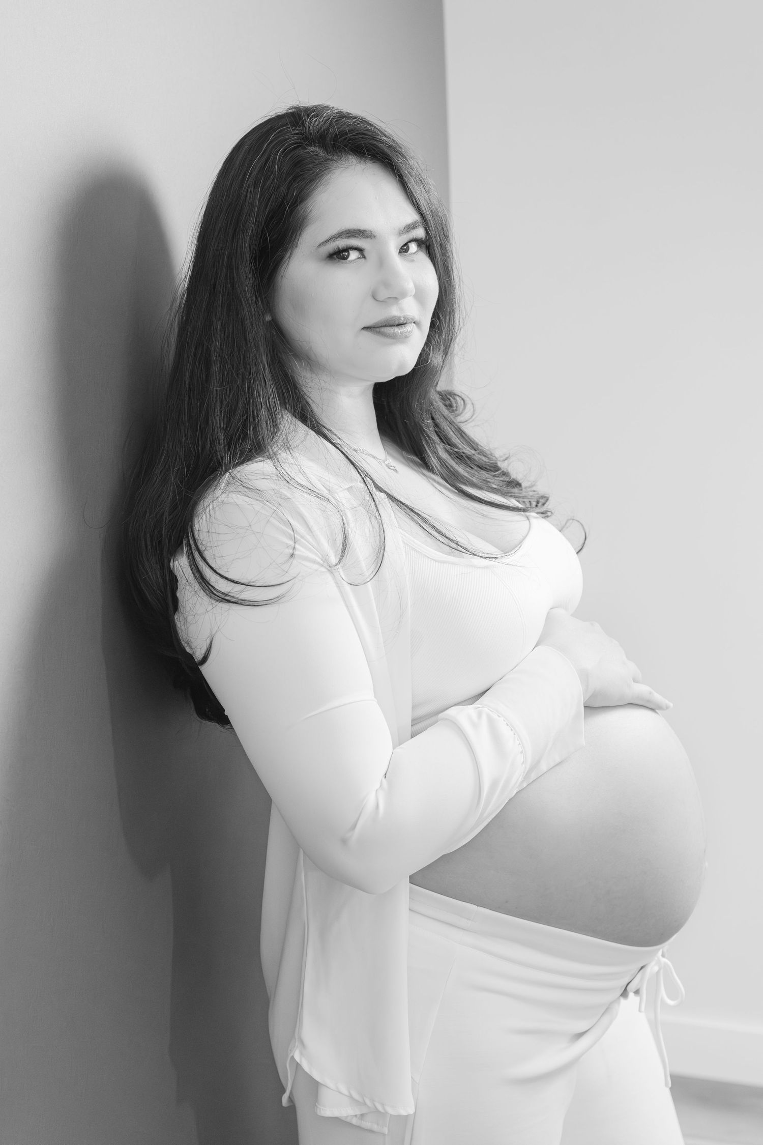 Pregnant woman studio maternity portrait leaning against wall, St. Albert maternity photographer