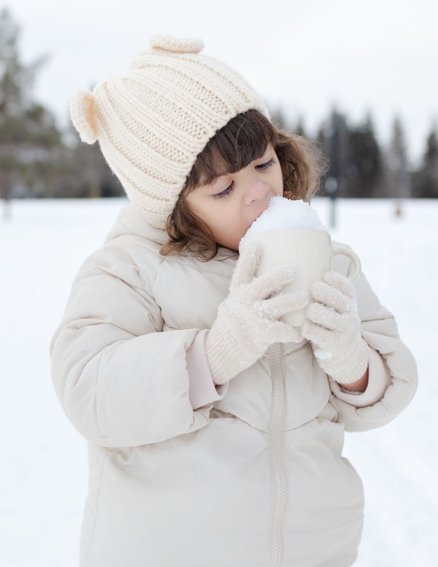 girl drinking hot chocolate in winter portrait session St Albert photographer