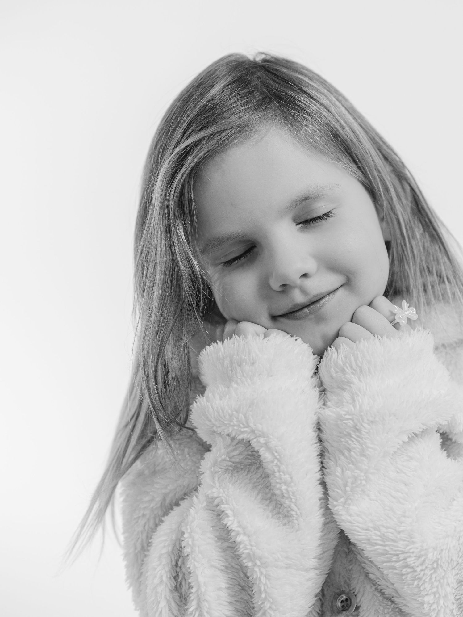 smiling young girl portrait with hands under chin black and white studio child photography St Albert