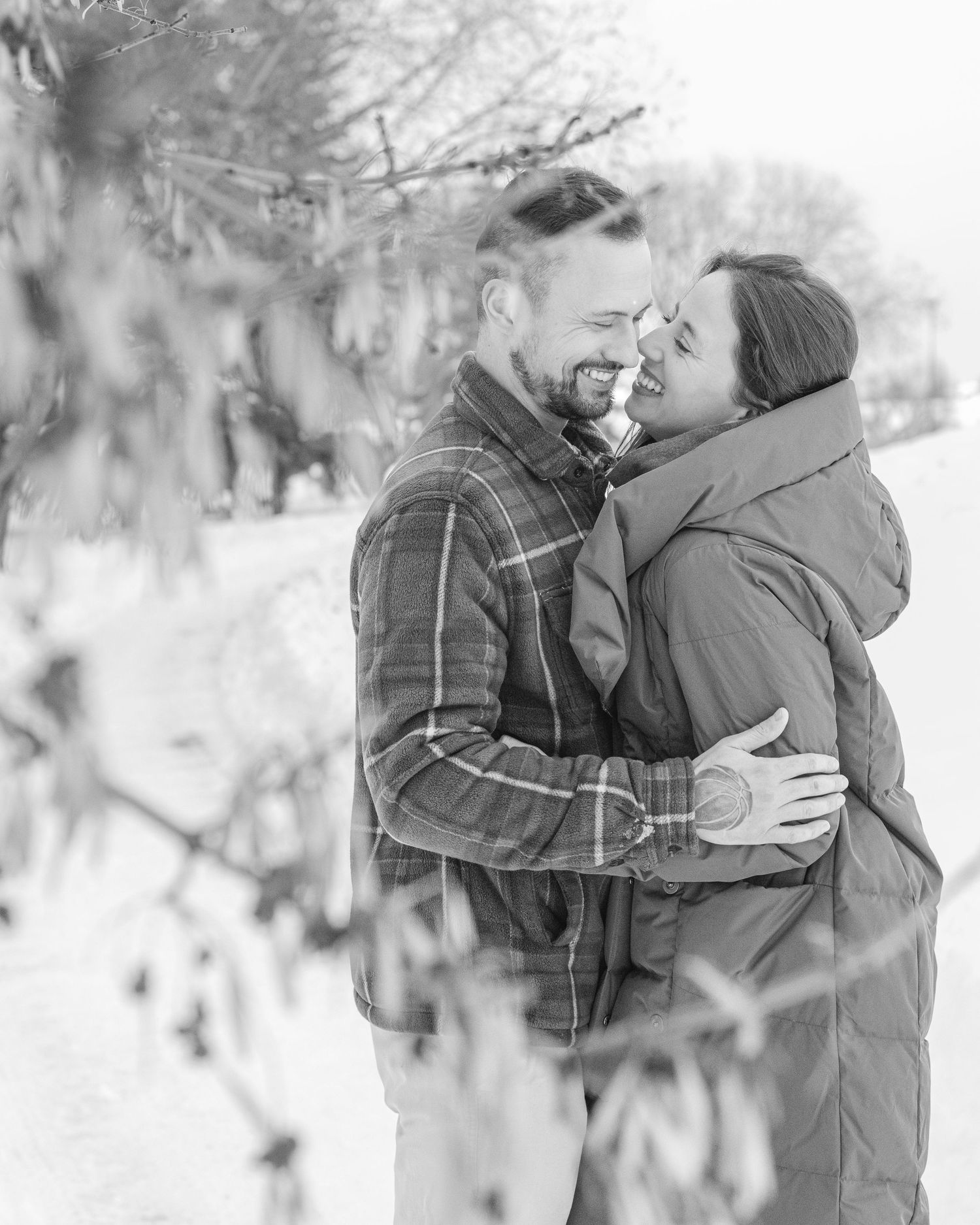 Couple embracing outdoors in winter snow portrait session, St. Albert family photographer
