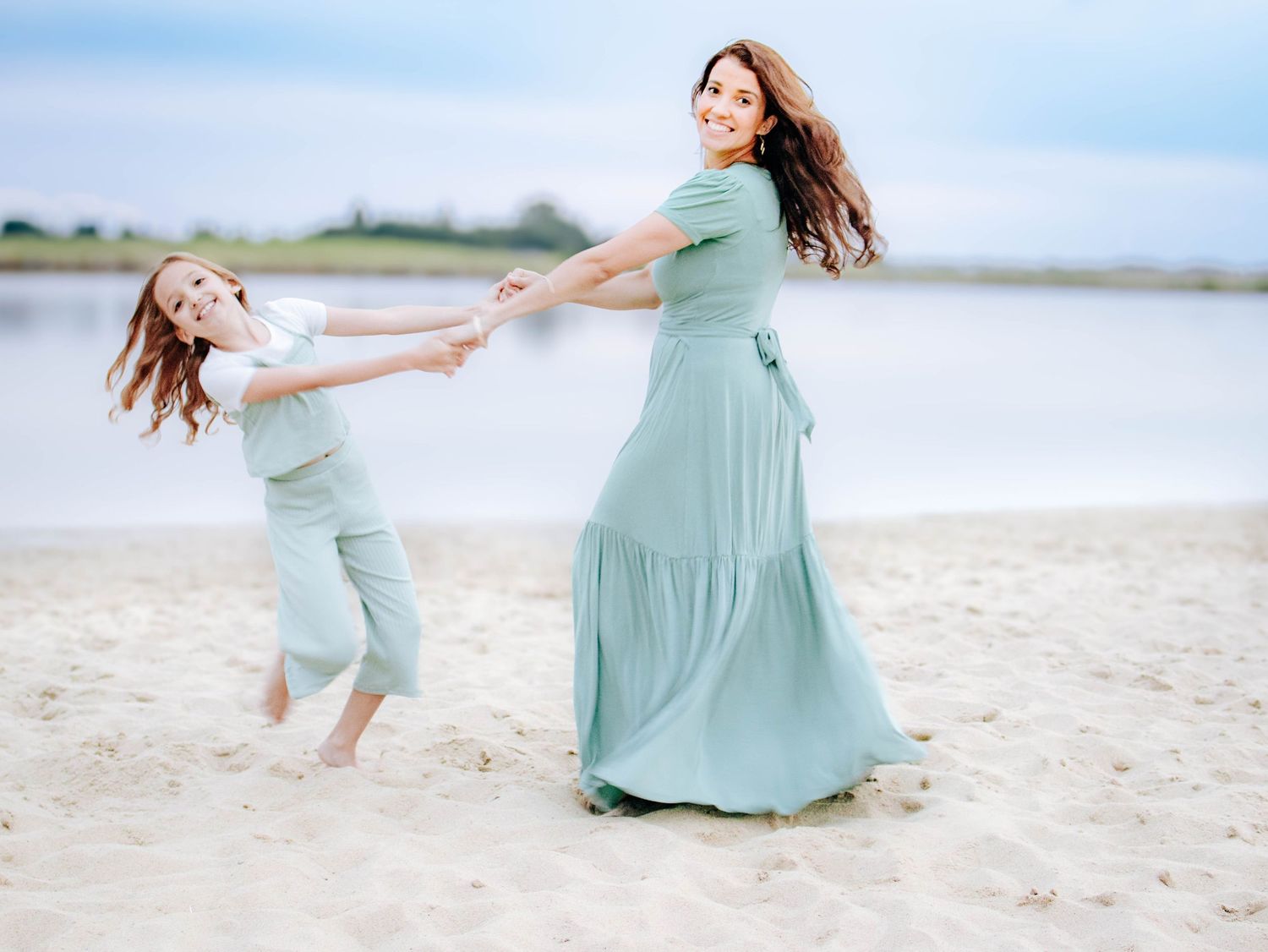 mother and daughter spinning and playing on beach outdoor family photography St Albert photographer