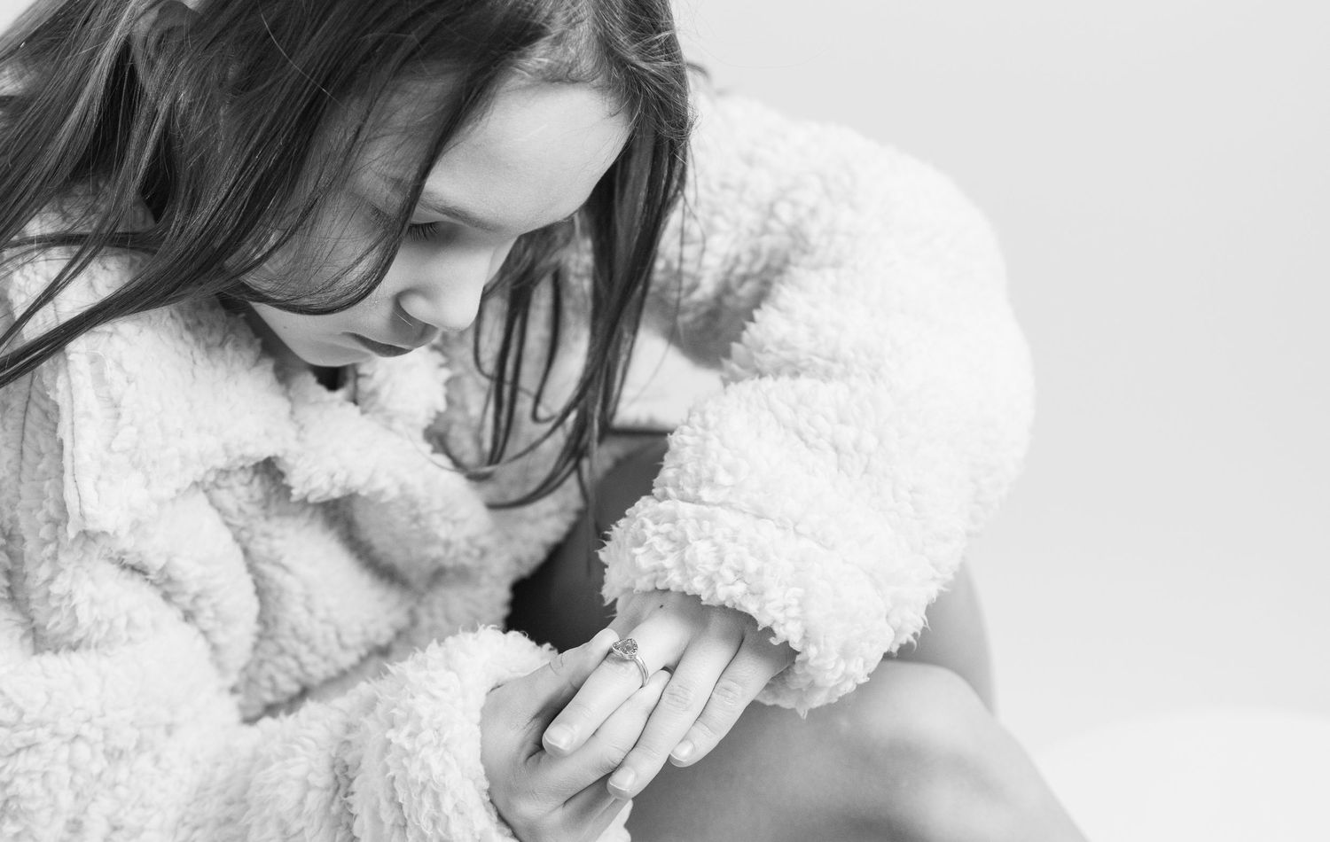 black and white portrait of girl in soft sweater looking down studio child photography St Albert