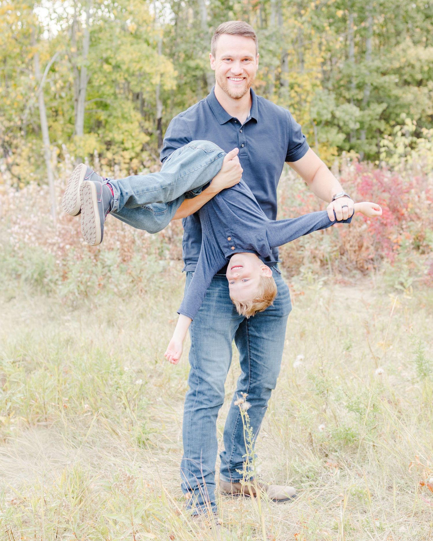 father playing with child outdoors candid family moment St Albert family photographer