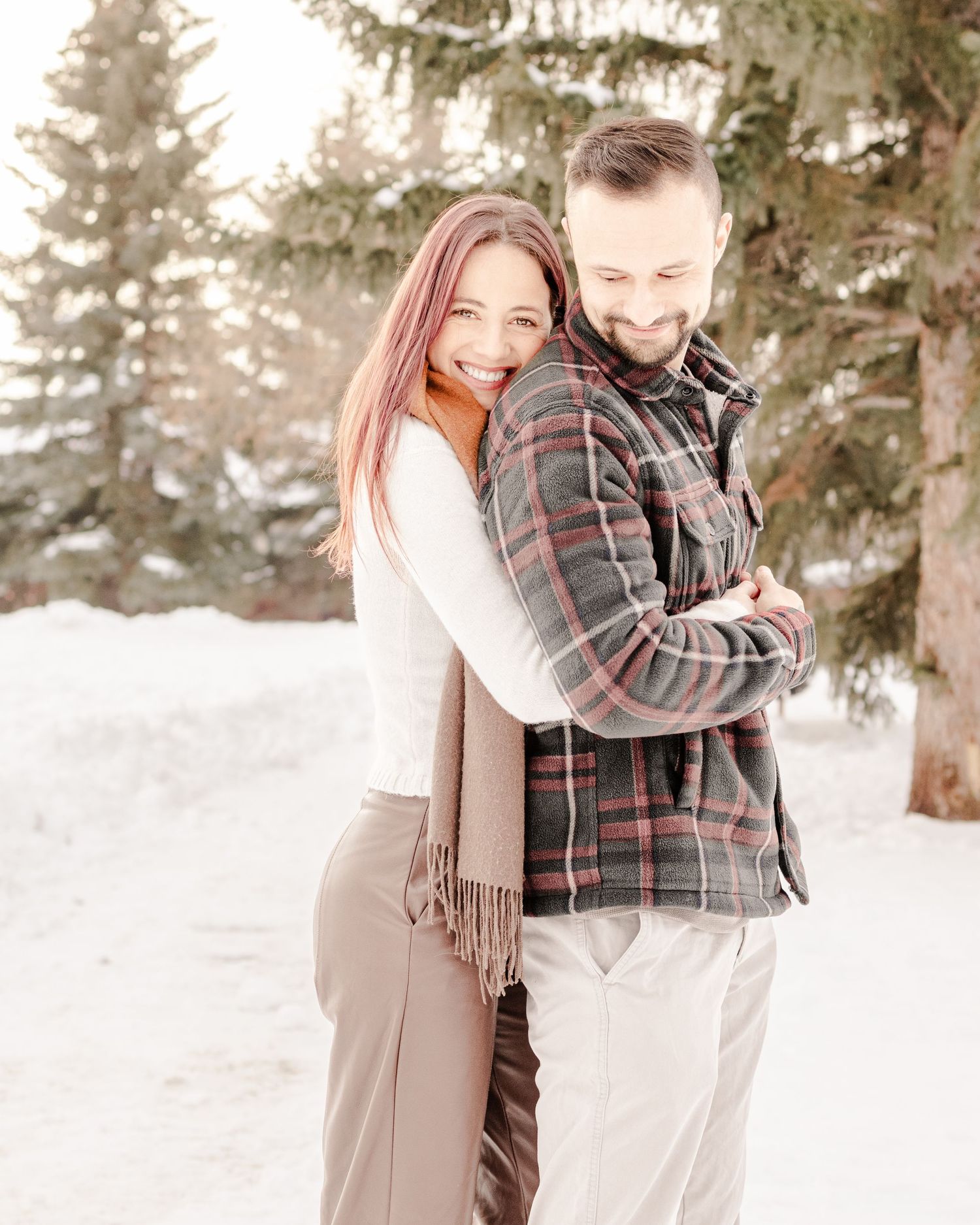 Couple embracing outdoors in winter snow portrait session, St. Albert family photographer