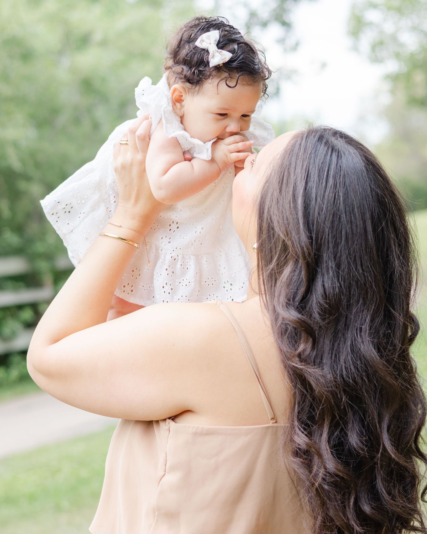 mother lifting baby girl outdoors candid motherhood photography St Albert family photographer