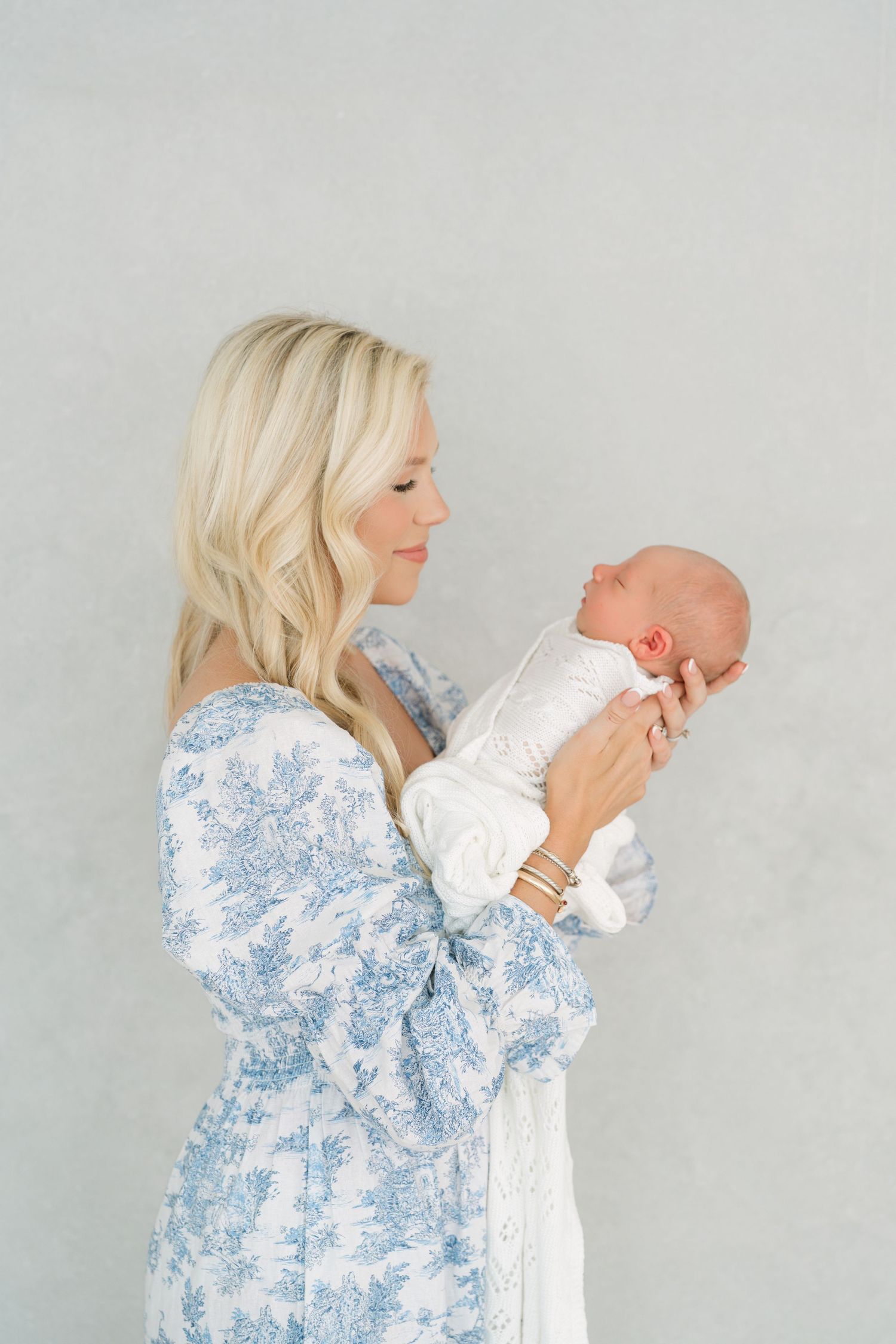 Motherhood portrait of mother holding swaddled newborn in Clarksville TN photography studio