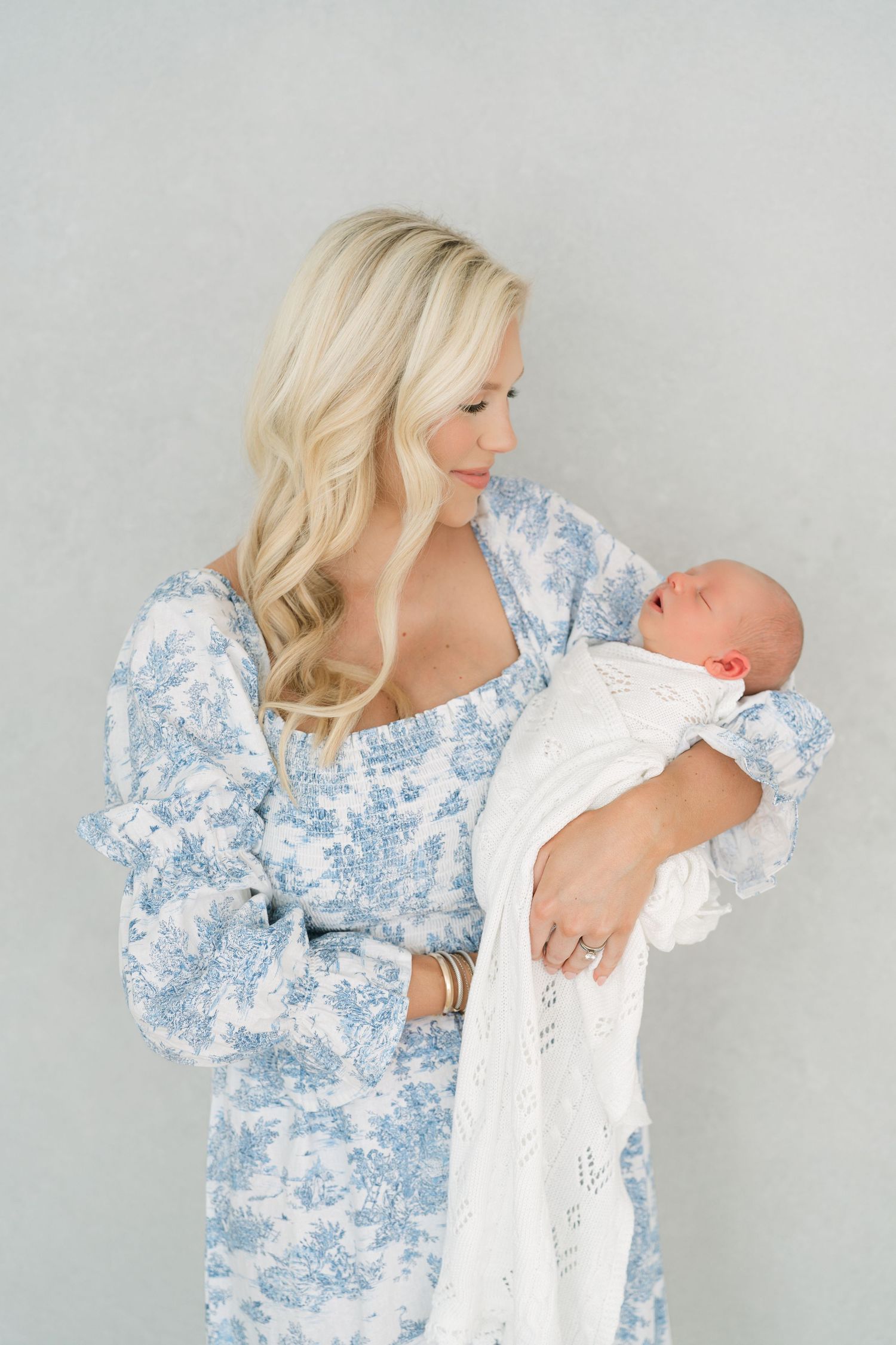 Mother holding newborn baby during studio newborn session in Clarksville TN