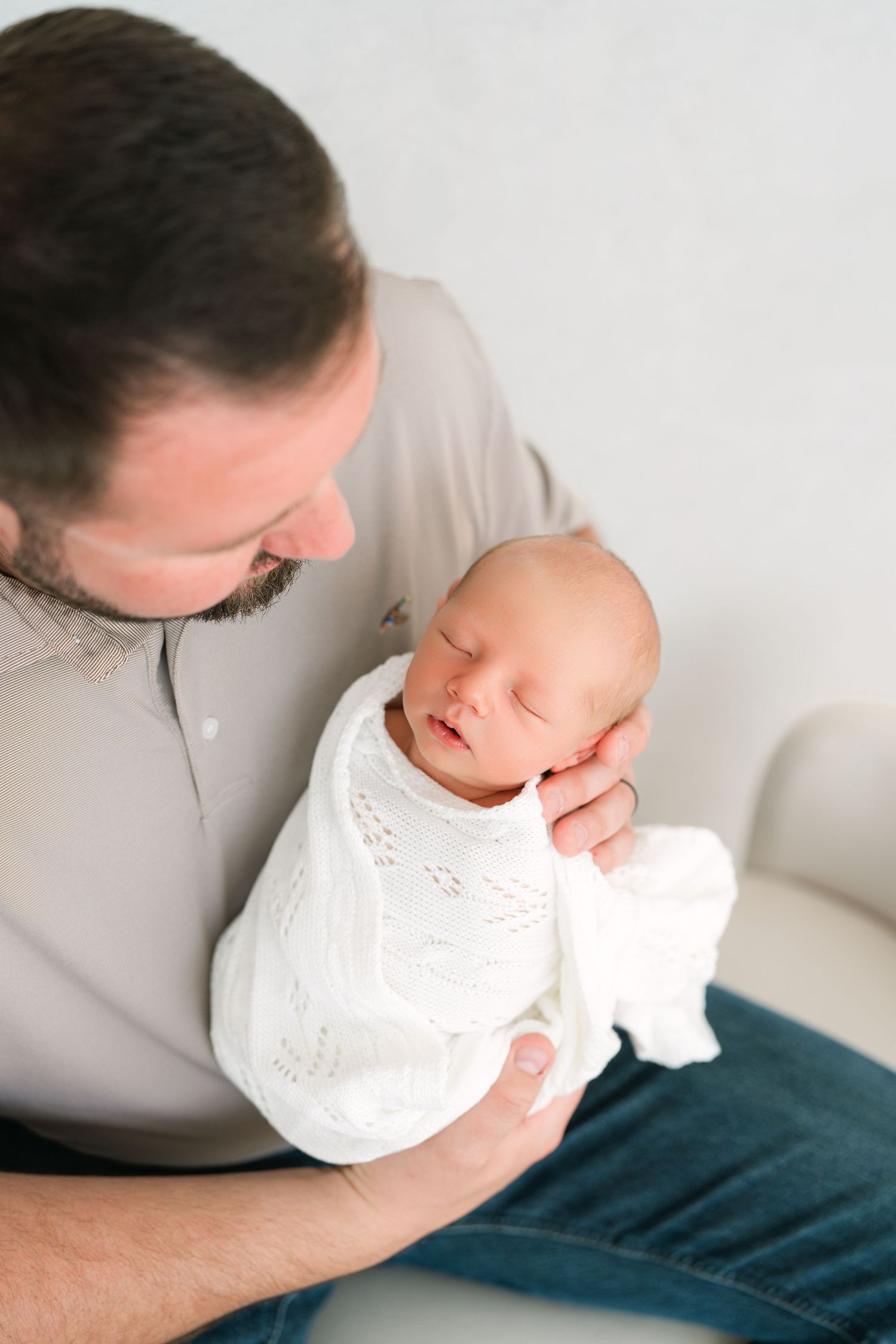 father holding newborn baby during studio newborn photography session in Clarksville TN