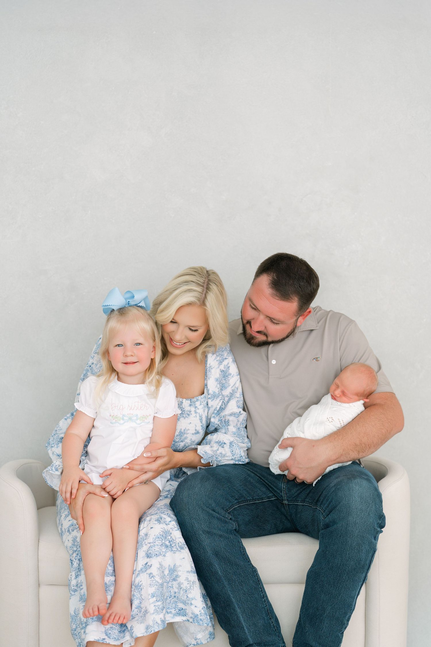 Family newborn photography session in Clarksville TN studio with parents and siblings