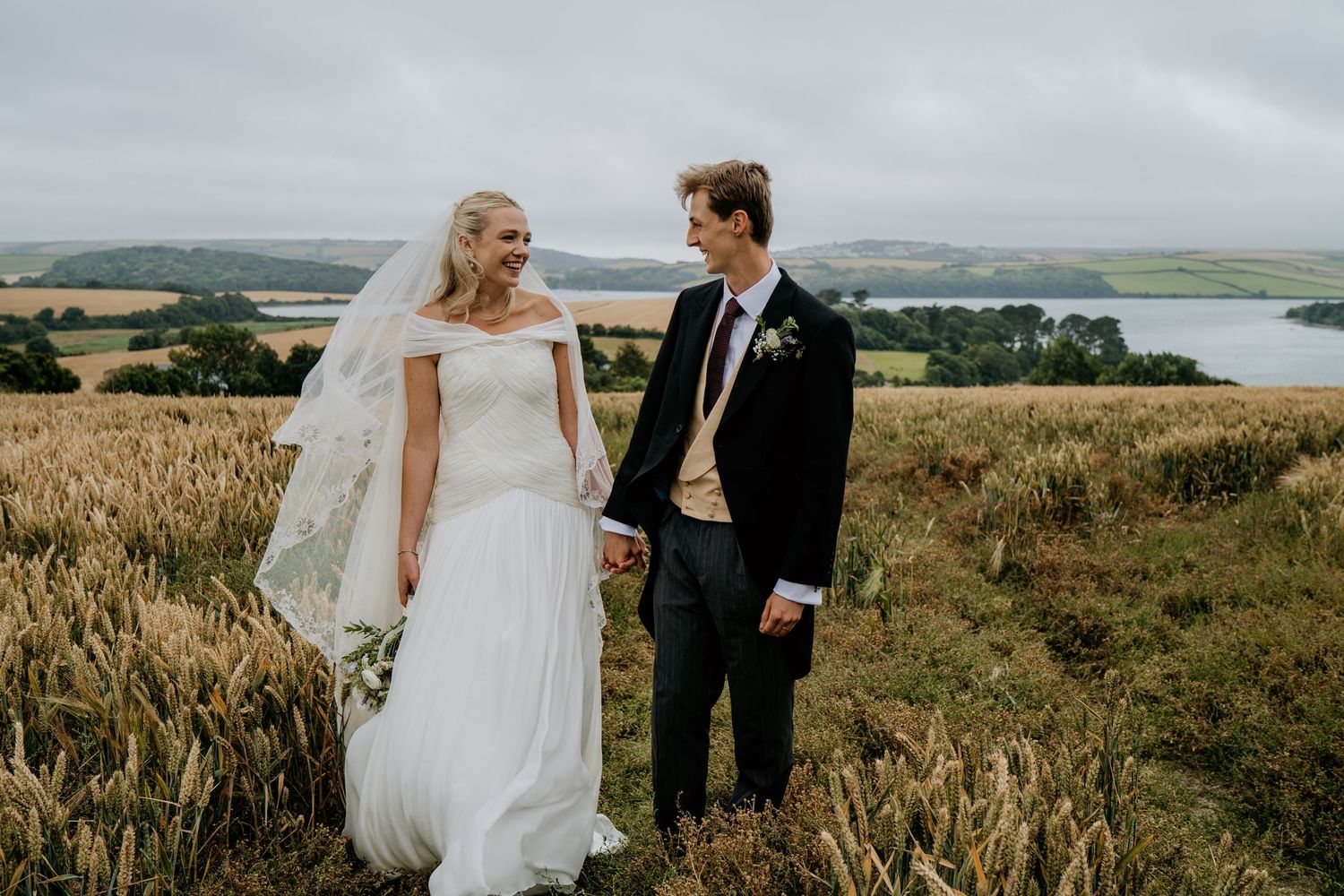 Bride and groom posing by the Salcombe Estuary, Devon wedding photographer; Capture You Photography