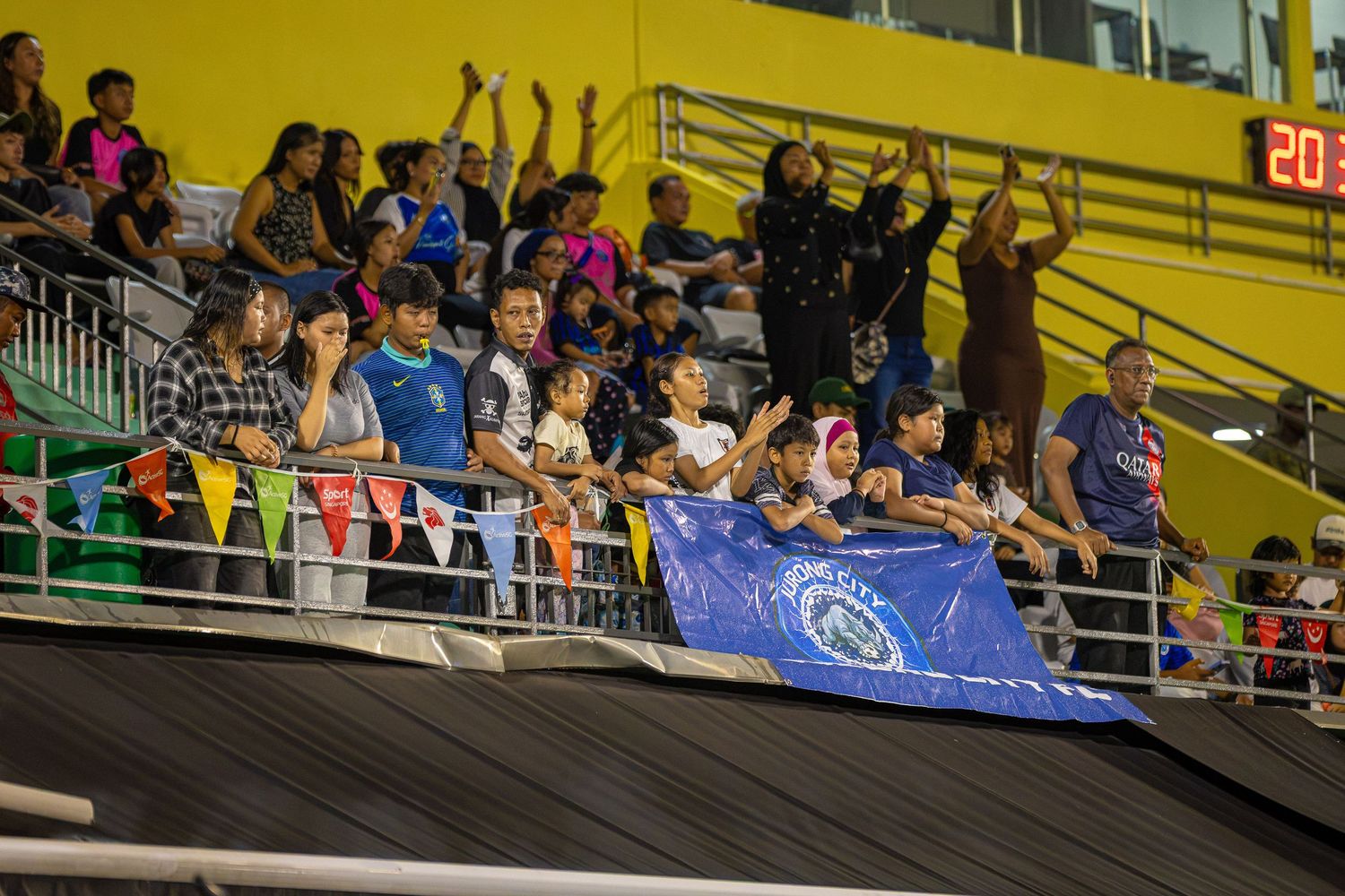 Jurong City FC fans cheering their team in the IWL 2026 Final at Jurong East Stadium
