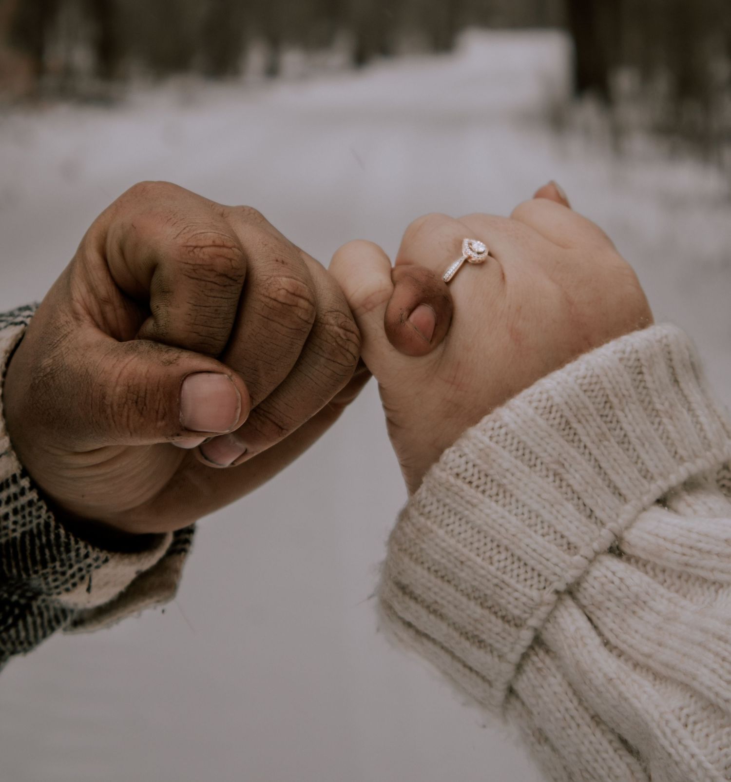 Close up of hands pulling on a cozy knit sweater sleeve in soft beige color.